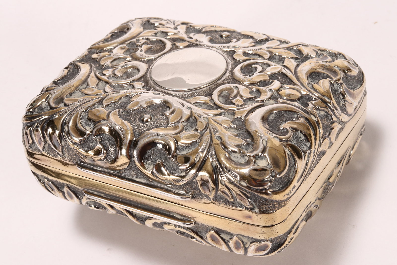 Late Victorian Gilt Sterling Silver Cigar Box,: hallmarked London, 1897, TW, of rounded rectangular form, heavily embossed with scrolling acanthus, with gilt interior, total weight 178g, 4cm x 9.5cm x 7.5cm