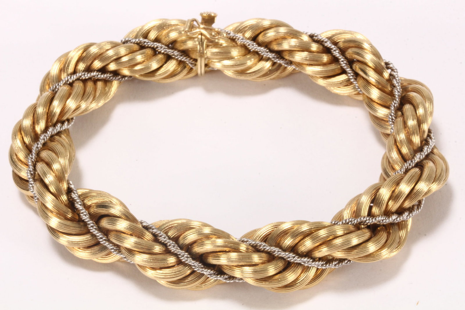 Italian 18ct Duotone Gold Bracelet,: stamped 750, in thick interwoven rope link, with smaller white gold rope link accent, uniting via an integrated box link clasp with safety latch, total weight 49g, total length 21cm