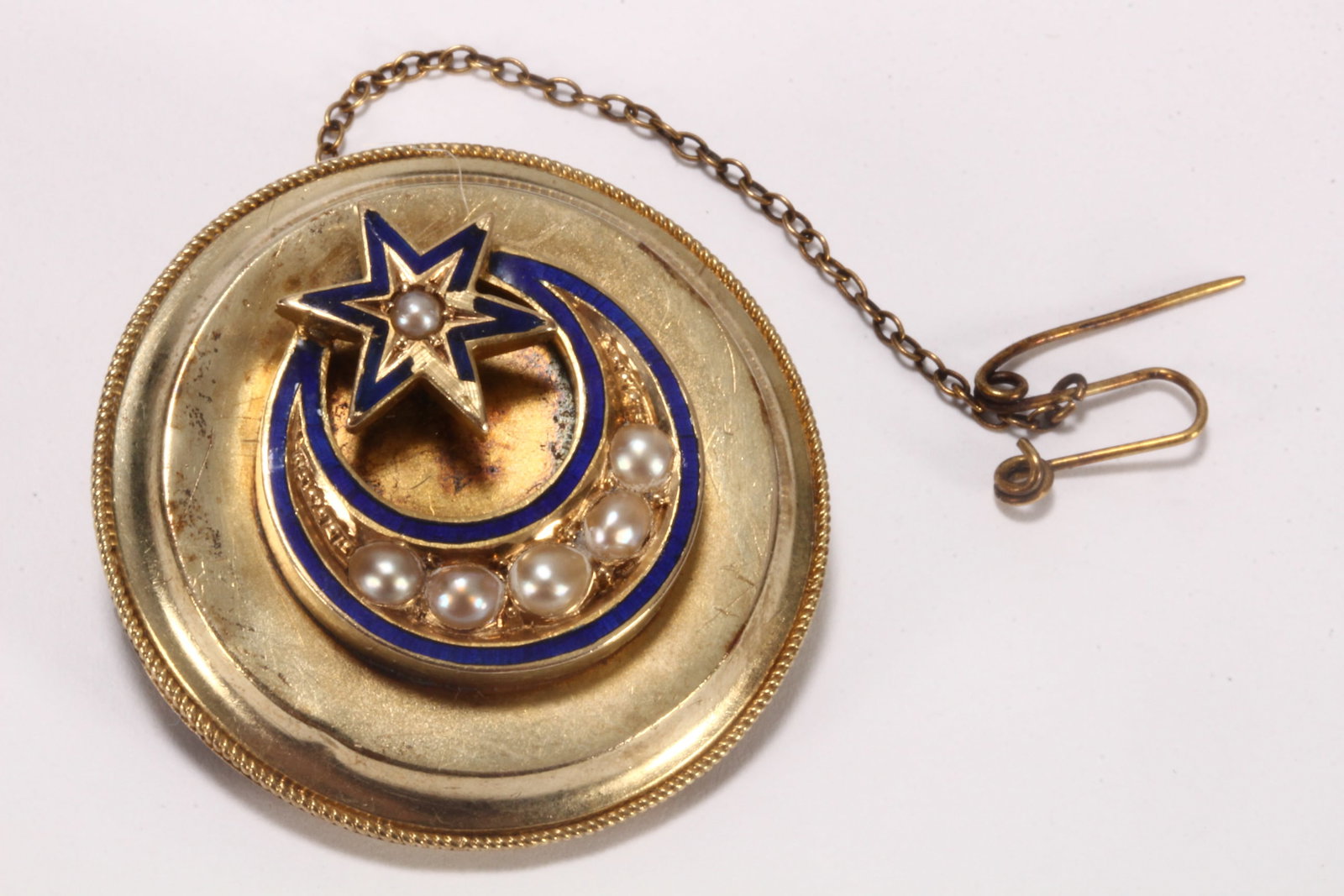 Victorian 15ct Gold Mourning Brooch,: unmarked (acid tested minimum 14ct), of circular form, with central crescent moon and star accented in blue enamels and seed pearls, within a rope twist surround, the verso with woven hair panel, with