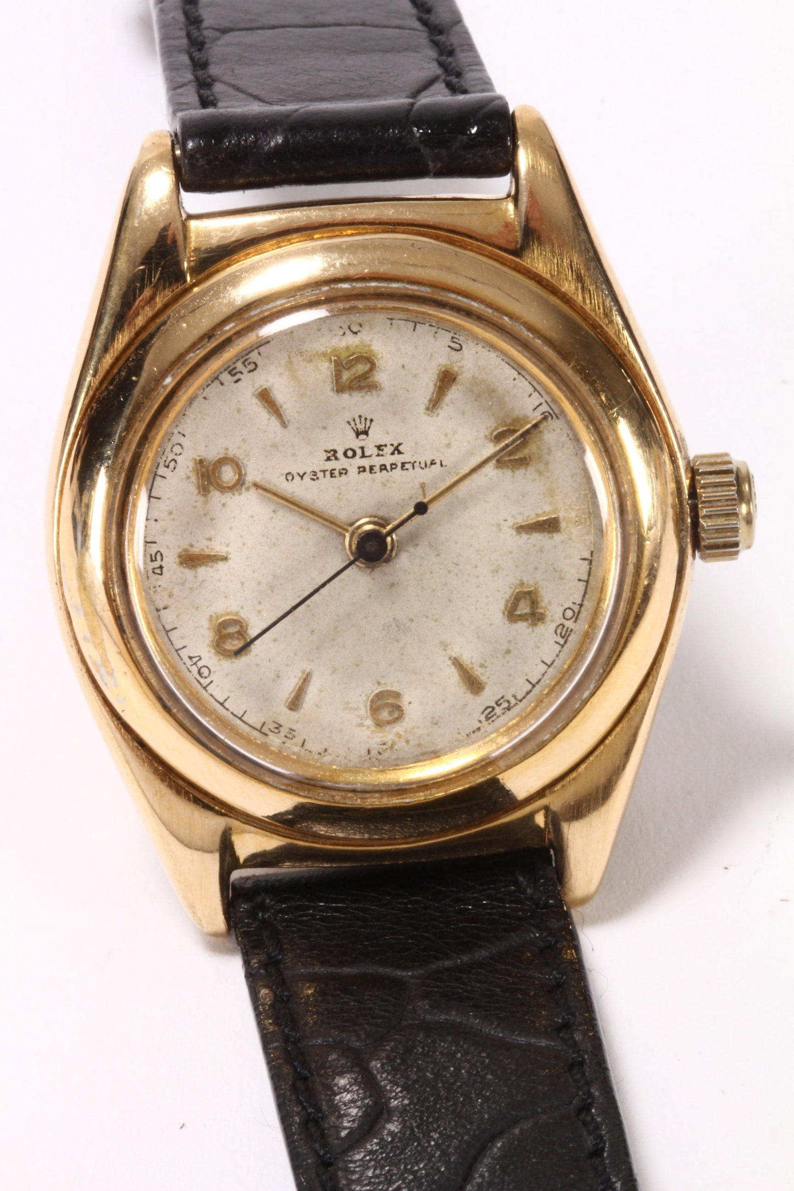 Rolex 'Oyster Perpetual' Bubble Back Wristwatch,: in gold plated case with 'bubble' back, with cal.1215 17 jewel manual wind movement, #74476, movement signed 'Montres Rolex/Geneva Swiss', with off white dial and alternating Arabic and baton hour mar
