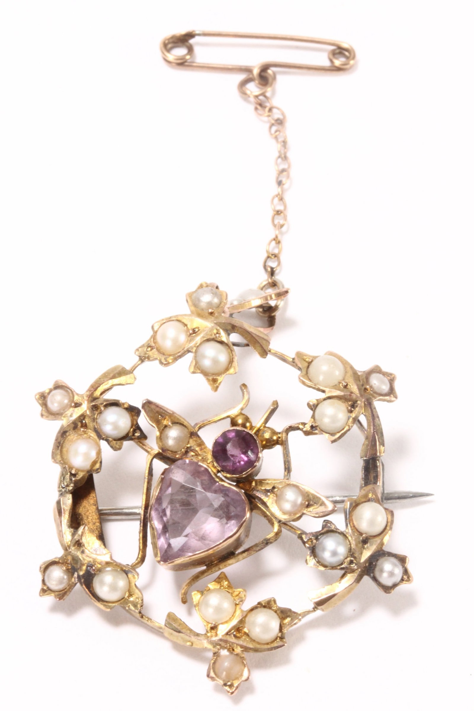 Edwardian 9ct Gold Amethyst and Seed Pearl Brooch,: unmarked (acid tested 9ct minimum fineness), of pierced circular form, with fruiting vine motifs, accented with seed pearls and amethyst stones, with gold safety chain and pin, (note: can also be used