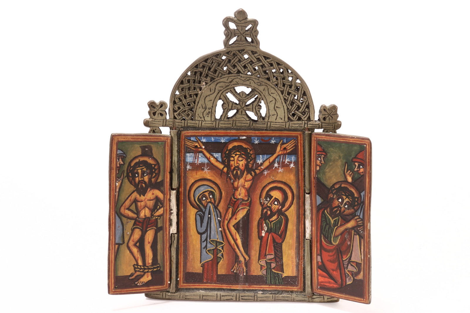 Ethiopian Orthodox Christian Triptych,: with central arched panel flanked by side panels, painted with a scene of the crucifixion, in tones of blue, green and red, 16cm x 14cm