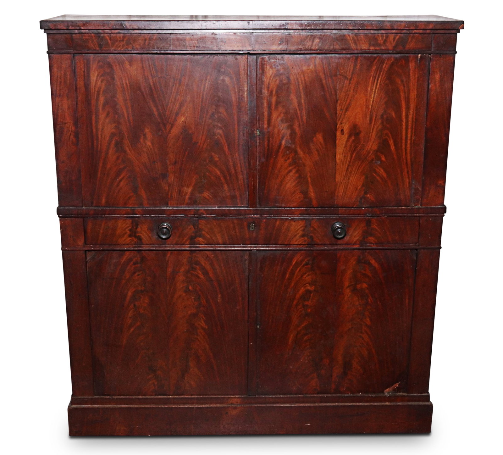 Regency Flamed Mahogany Narrow Cabinet,: of rectangular form, set with a pair of doors above a long narrow drawer, above a pair of doors all with quarter sawn veneer, the whole raised on a plinth base, a/f, 145.5cm x 130cm x 37cm