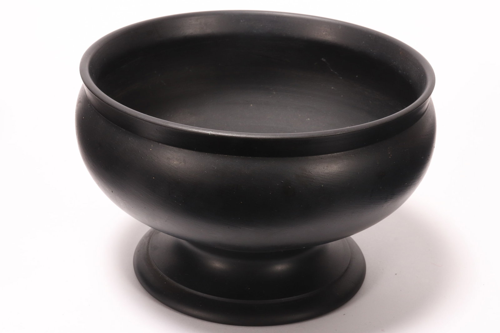 Wedgwood Black Basalt Pedestal Bowl,: of plain squat form, raised on a stepped circular foot, impressed Wedgwood//Made in England, height 10.5cm and diameter 16.5cm