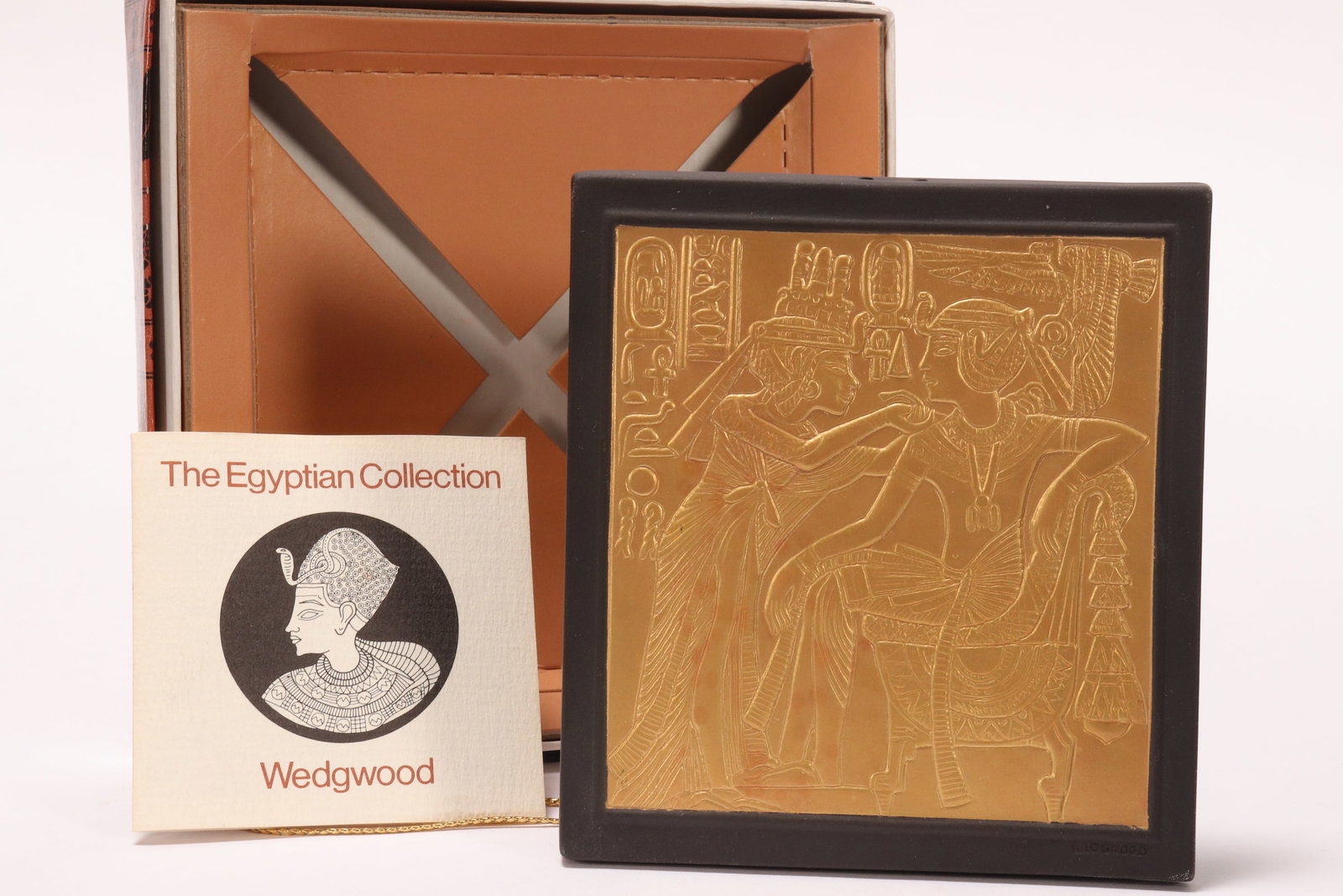 Wedgwood 'Lord of Diadems' Egyptian Plaque,: in gilded black basalt, depicting a scene from the golden shrine of the tomb of Tutankhamun, impressed Wedgwood//Made in England verso, 11.5cm x 10.5cm, in original box
