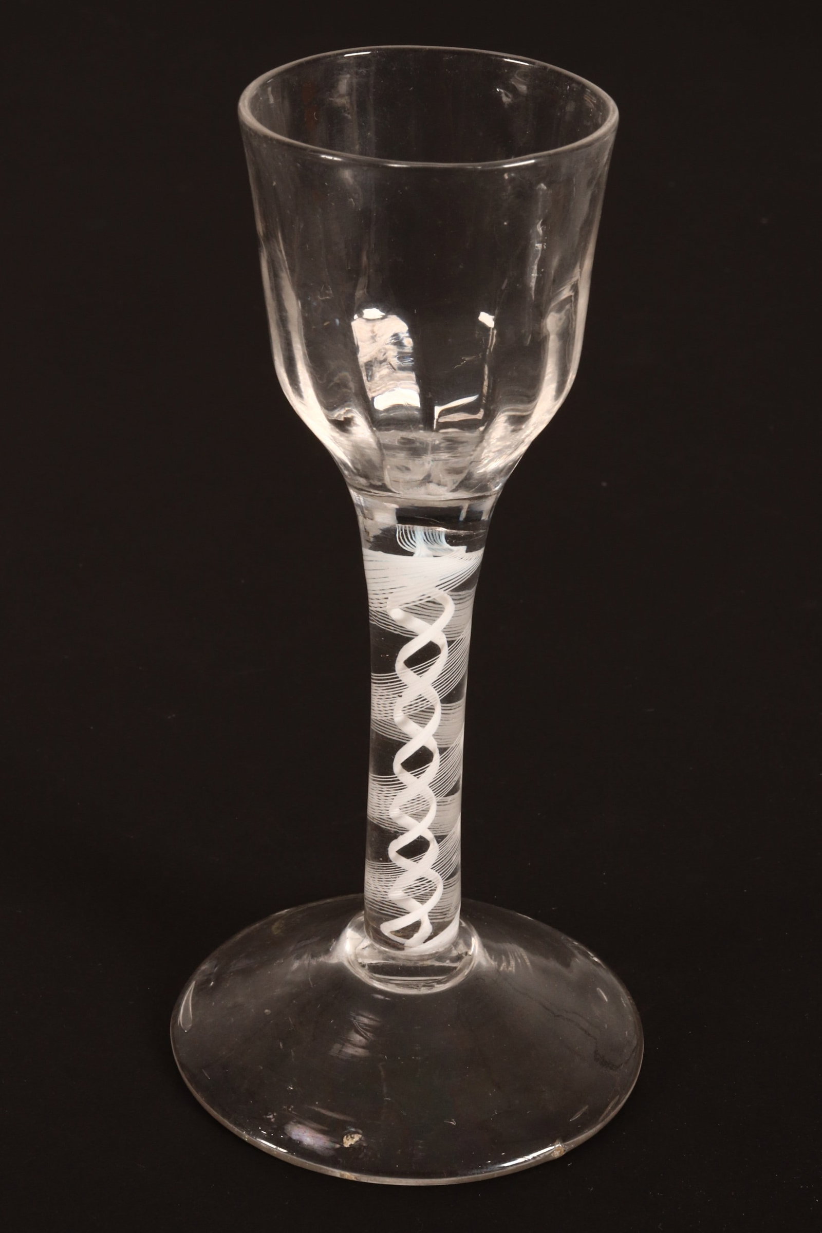 18th Century British Opaque Twist Wine Glass,: c.1765, with molded petal bowl, above a central corkscrew twist, with spiral twist surround, on conical foot, height 14cm