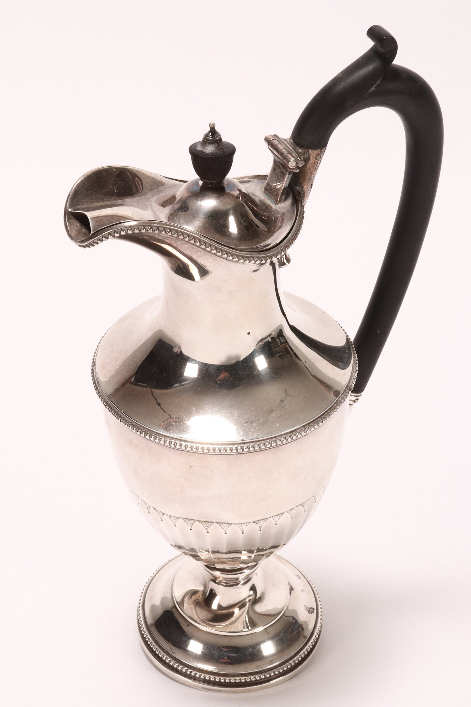 Victorian Sterling Silver Ewer,: hallmarked London, 1895, WBJ, of tapering form with hinged cover and timber insulated handle, decorated with beaded borders and a faceted lower body, set with scrolled thumb piece, raised on a stepped