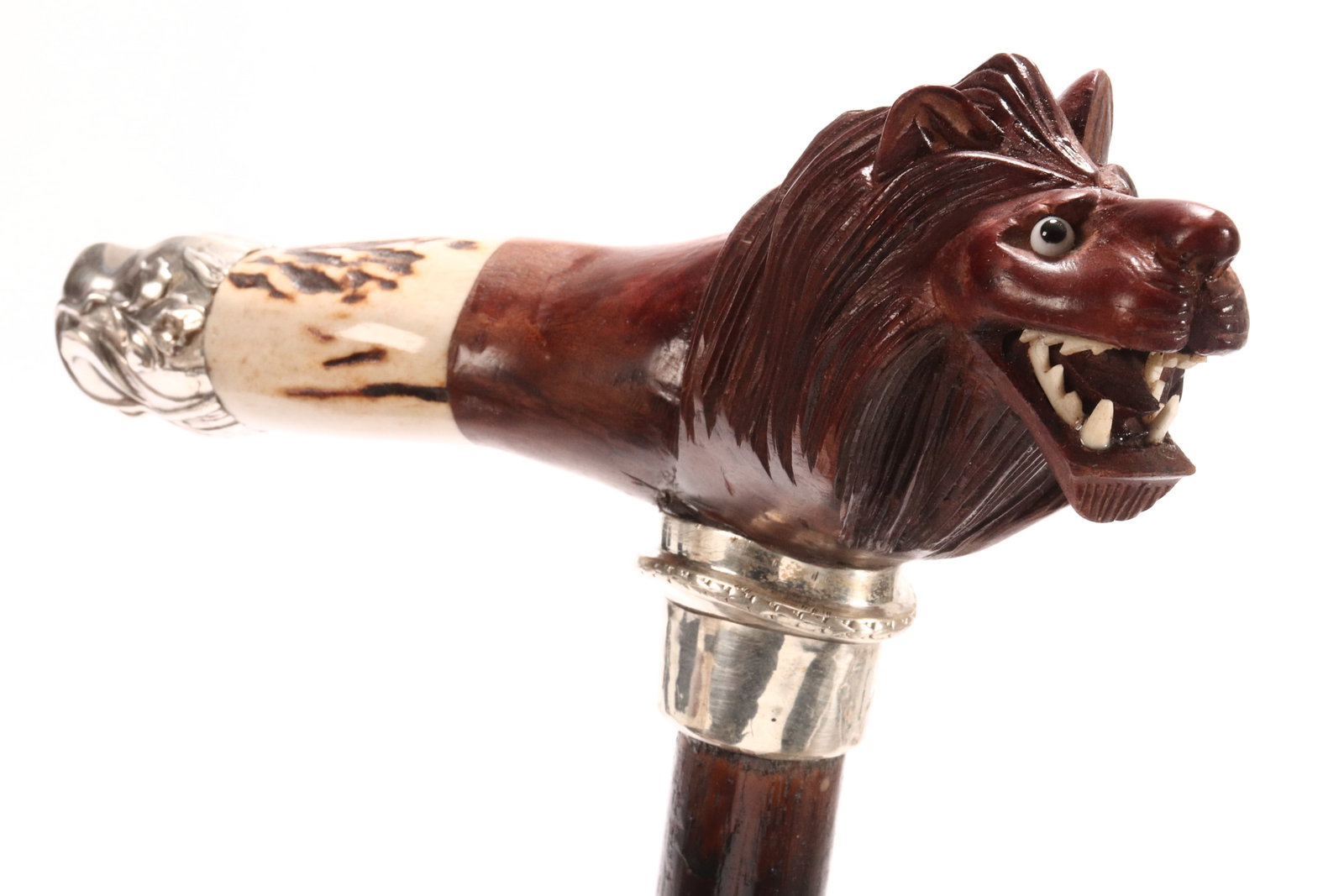 Walking Stick,: set with a carved wooden lion head handle, above a silver mount above a tapering support, length 97cm
