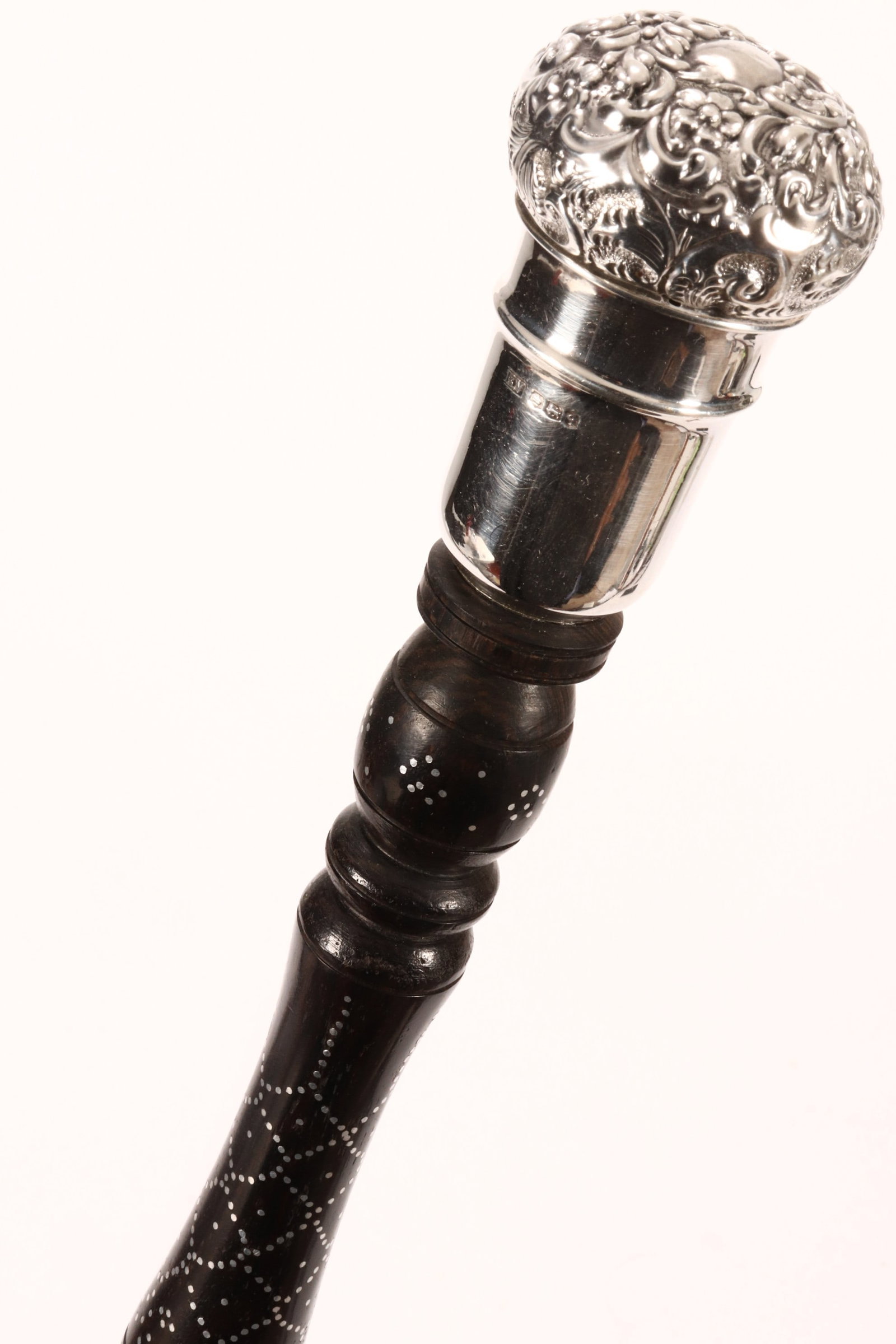 English Sterling Silver Handled Walking Stick,: the knop handle decorated with acanthus scroll above a turned handle with decorative silvered dot motifs, length 97cm