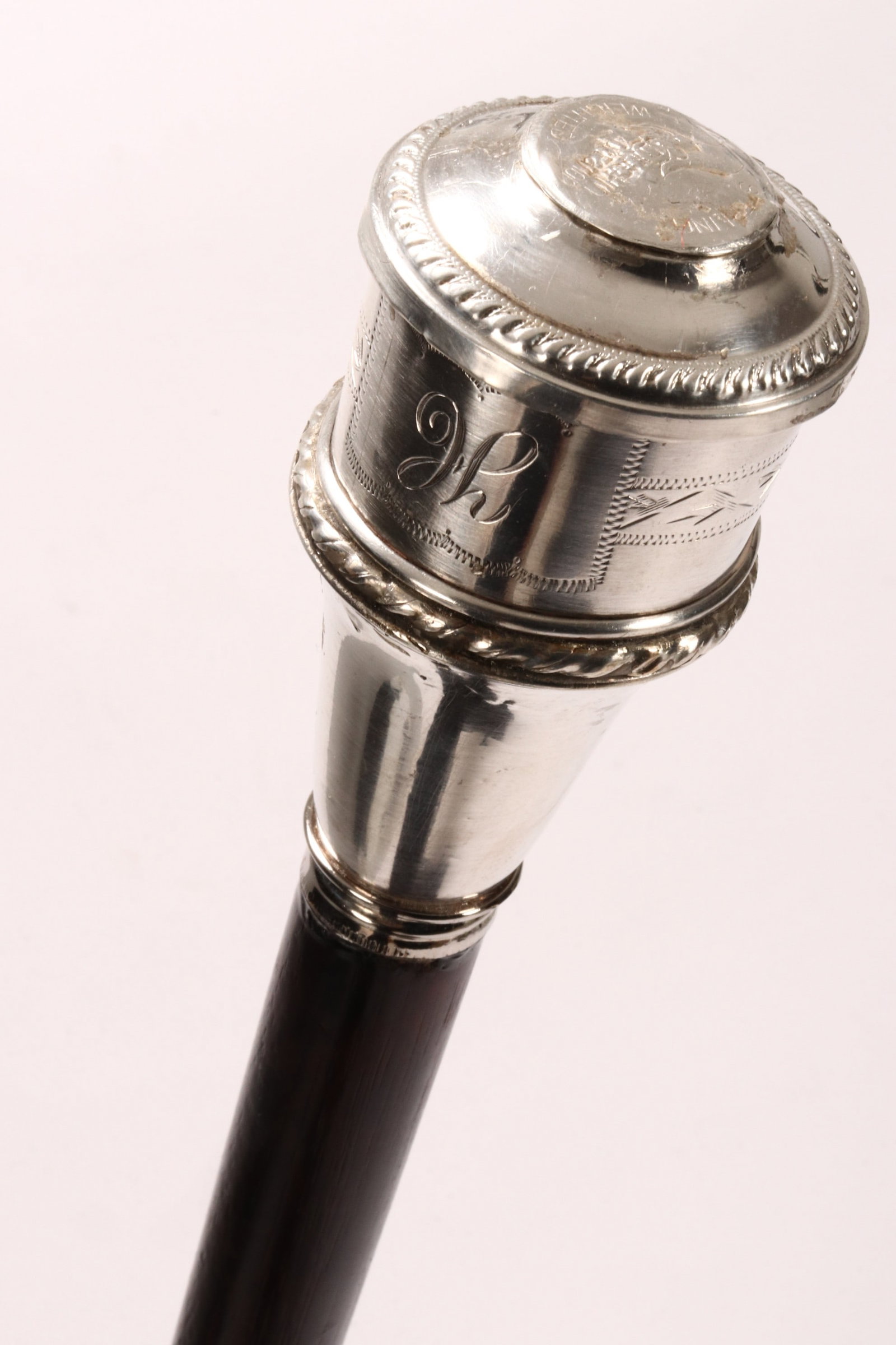 Walking Stick,: set with a silver handle of cylindrical tapering form,with engraved and gadrooned border, above a tapering support, length 100cm