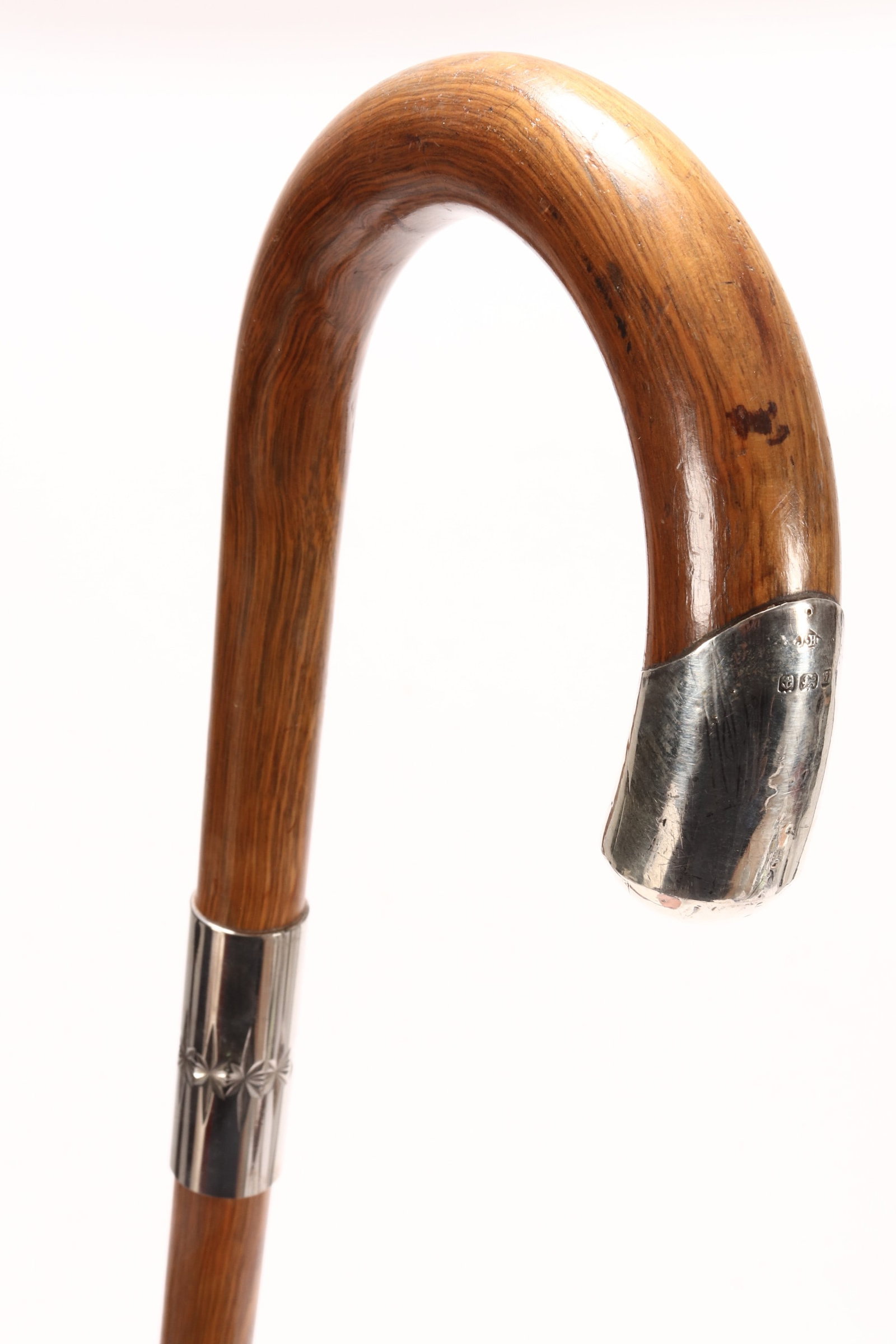 Walking Stick,: with a hooked end, set with silver mounts, above tapering support, length 92cm