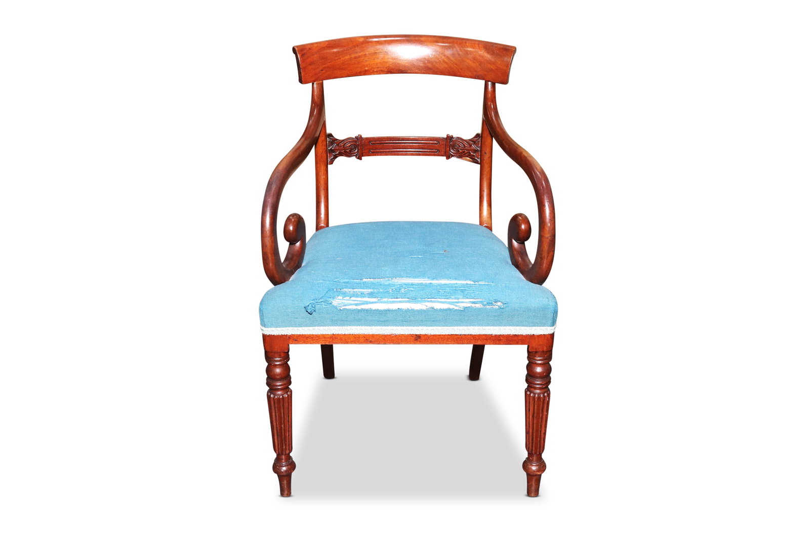 Regency Armchair,: with a curved crest rail, above a carved lower splat, above a blue upholstered over covered seat flanked by scrolled arms, raised on four turned reeded legs, a/f to fabric