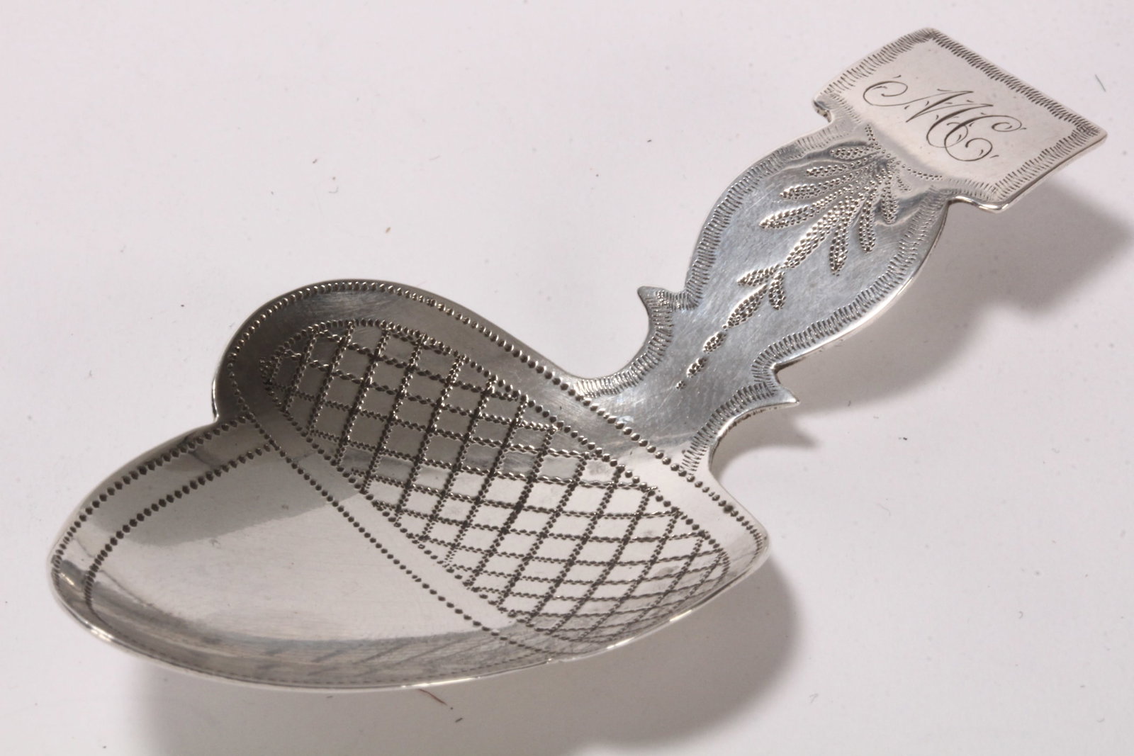 George III Sterling Silver Caddy Spoon,: hallmarked London, 1810, Elizabeth Morley, with shaped handle with monogram, above bright cut decoration, the bowl in the form of an acorn, total weight 8g, length 7.2cm