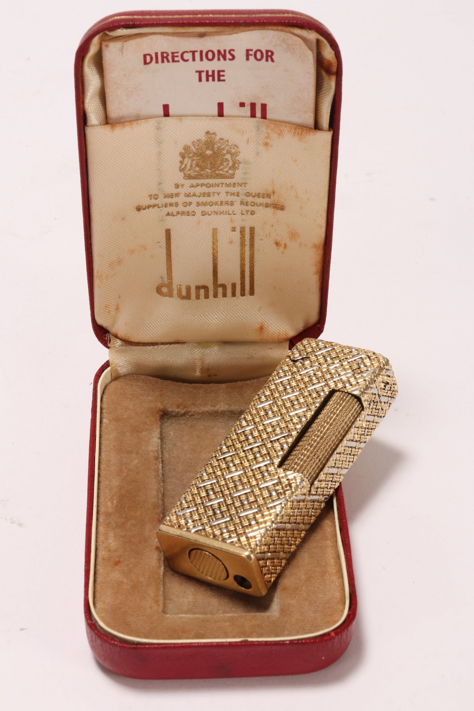 Dunhill 18ct Duotone Gold Lighter in Box,: stamped '750' to base, with 18ct duotone gold jacket overlay to case and cover, in interwoven design, in working condition, total weight 103g, 65 x 20 x 13mm, together with original Dunhill case with 