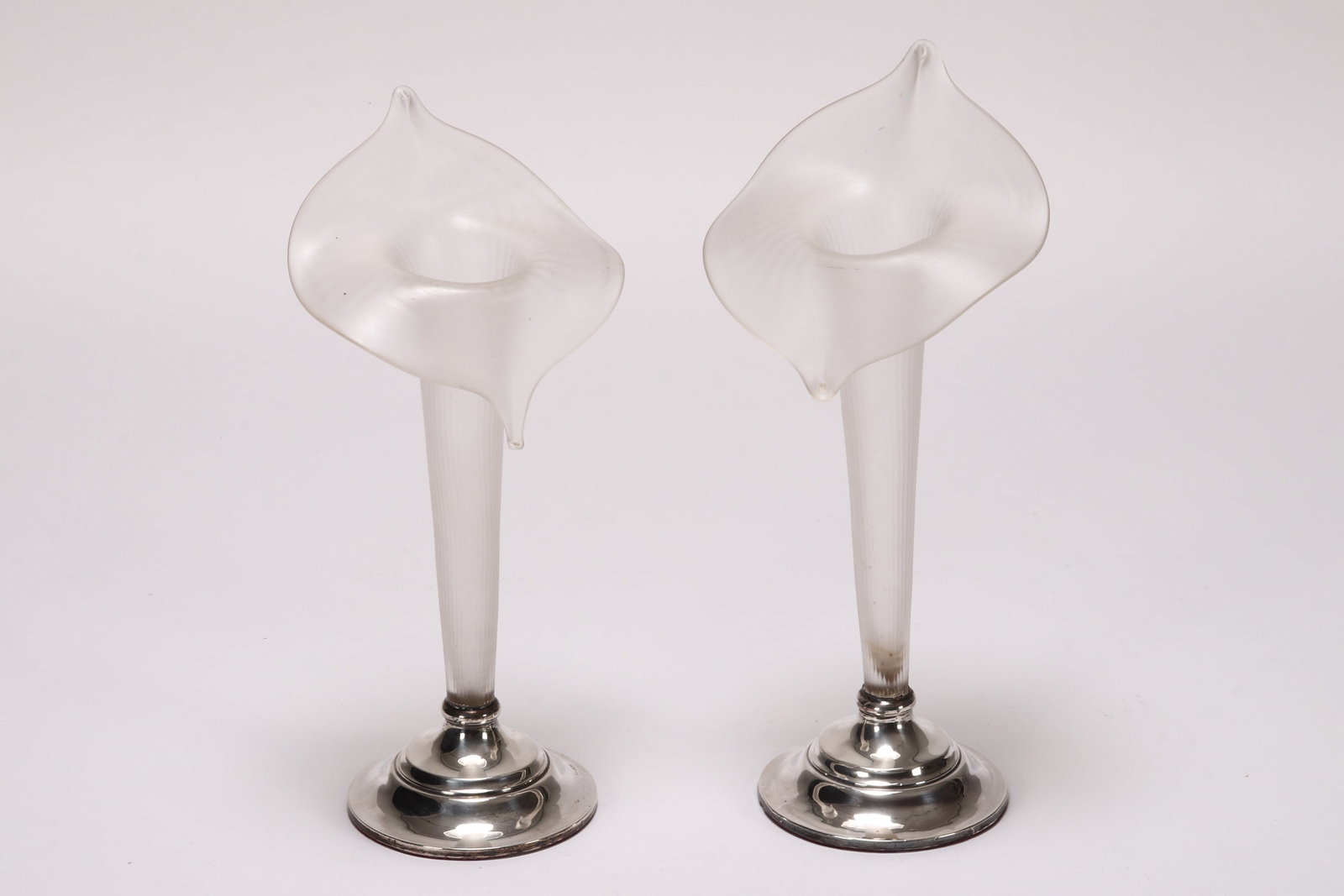 Near Pair of George V Sterling Silver & Glass Jack: in the Pulpit Vases, the stepped circular base hallmarked Birmingham, 1918, J&C, set below a textured frosted glass vase, a/f (repair to base), height 30.5cm and 31.5cm (2)