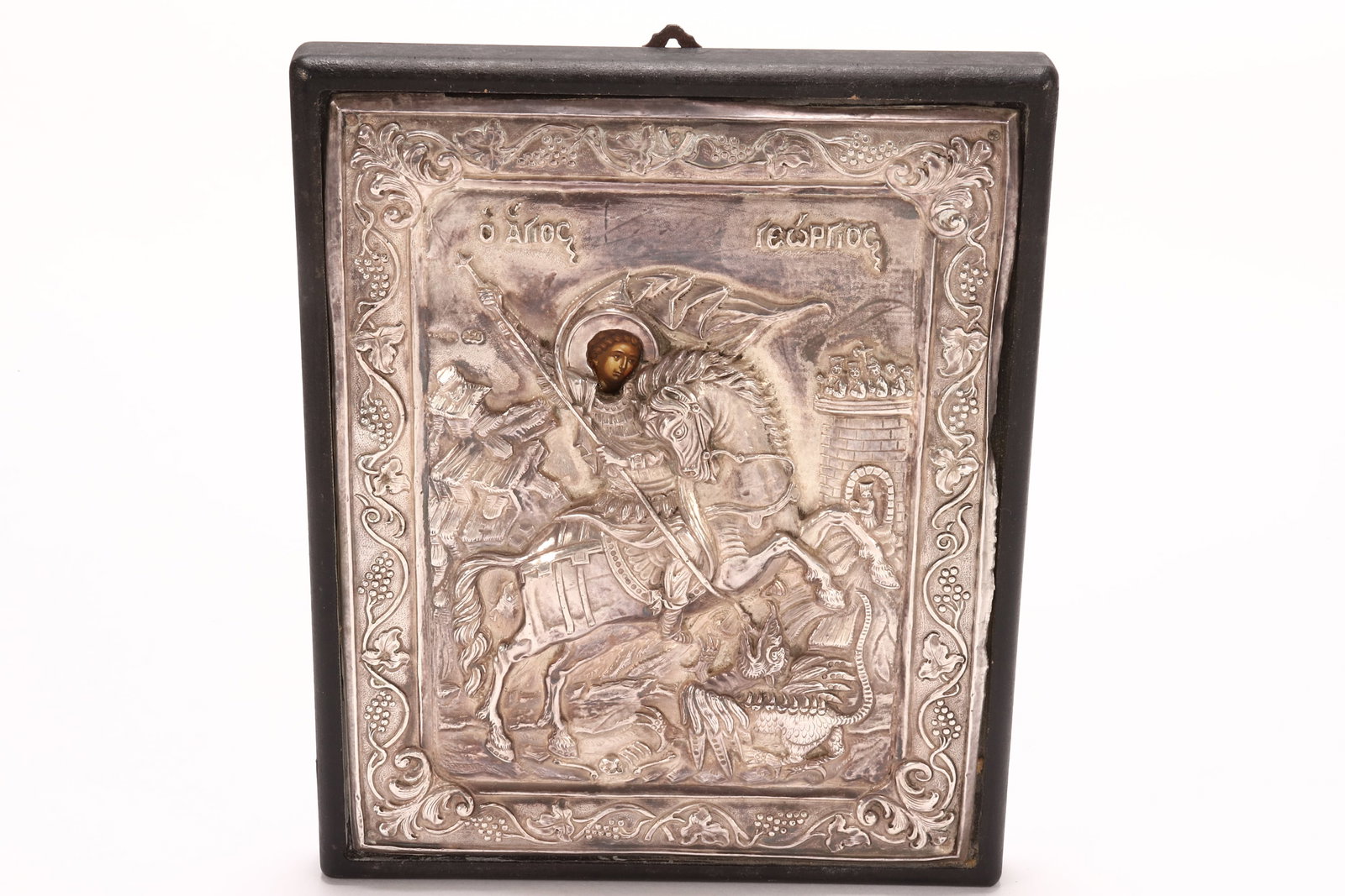 Framed Greek Silver Icon,: stamped for 950 fineness, of rectangular form, depicting St.George on horseback slaying the dragon, applied label to reverse, 21.5cm x 17cm