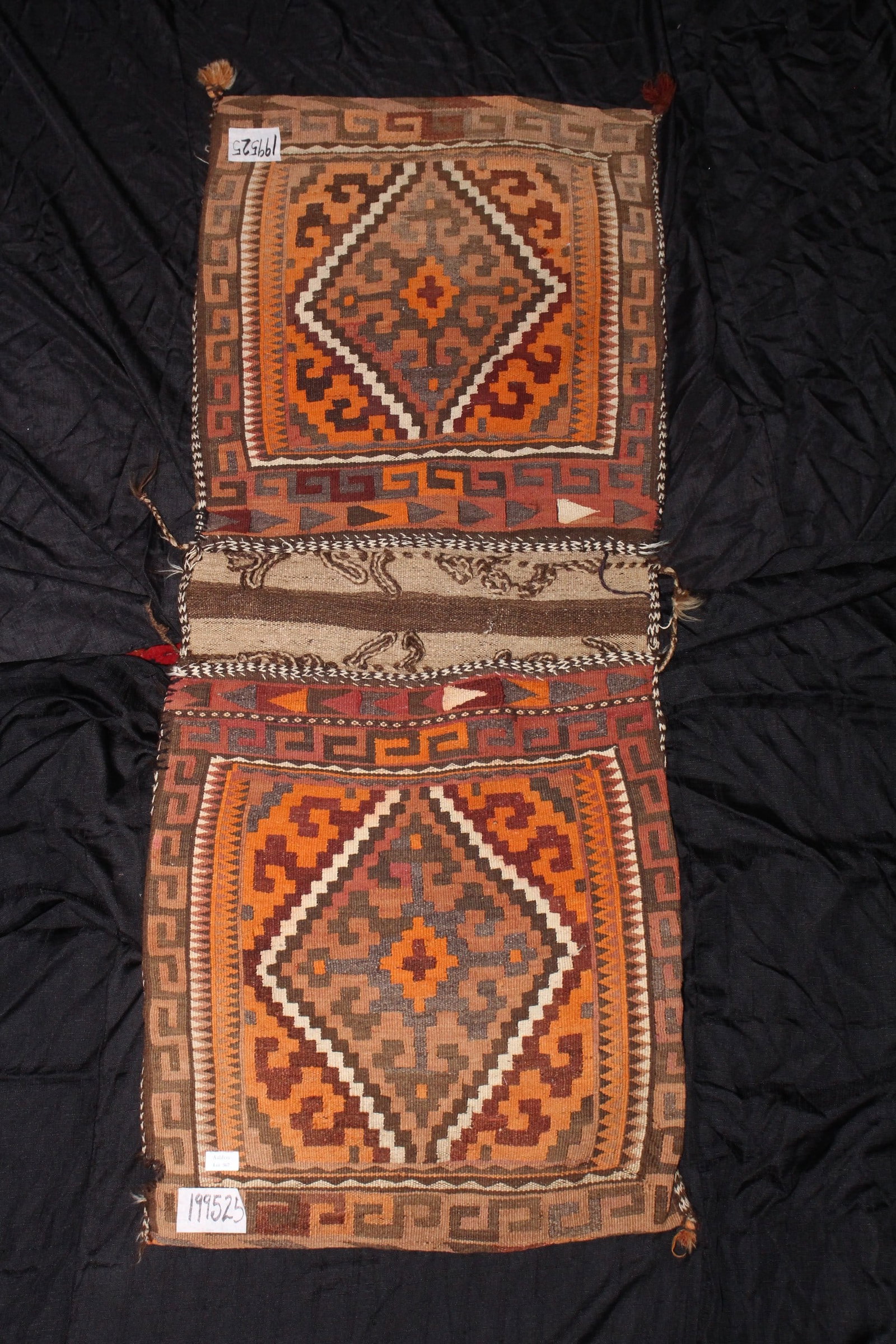 Afghan Tribal Saddle Bag,: of rectangular form with two compartments, decorated with geometric diamond motifs, in rich tones of orange, red and white, 152cm x 60cm