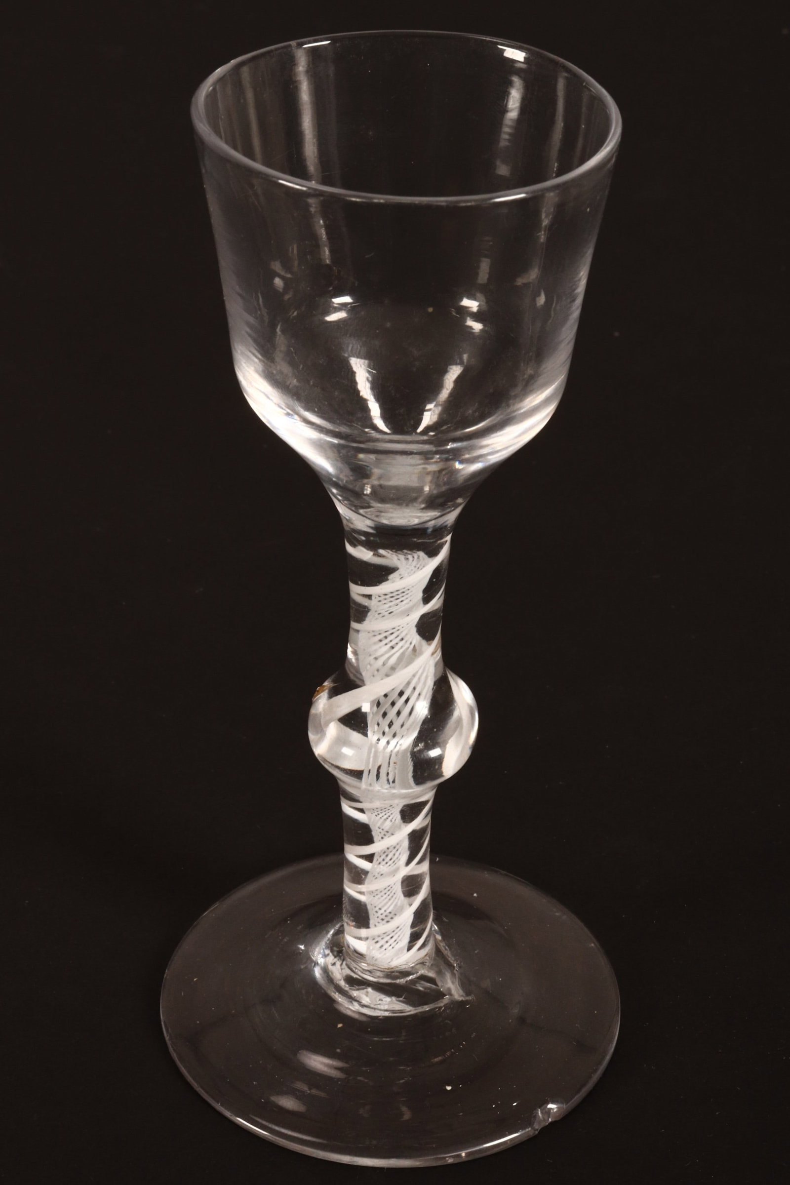 18th Century British Baluster Opaque Twist Wine Glass, c.1765,: with ogee shaped bowl, above a baluster knop stem with central spiral surrounded by twist, on a conical foot, a/f, height 15cm
