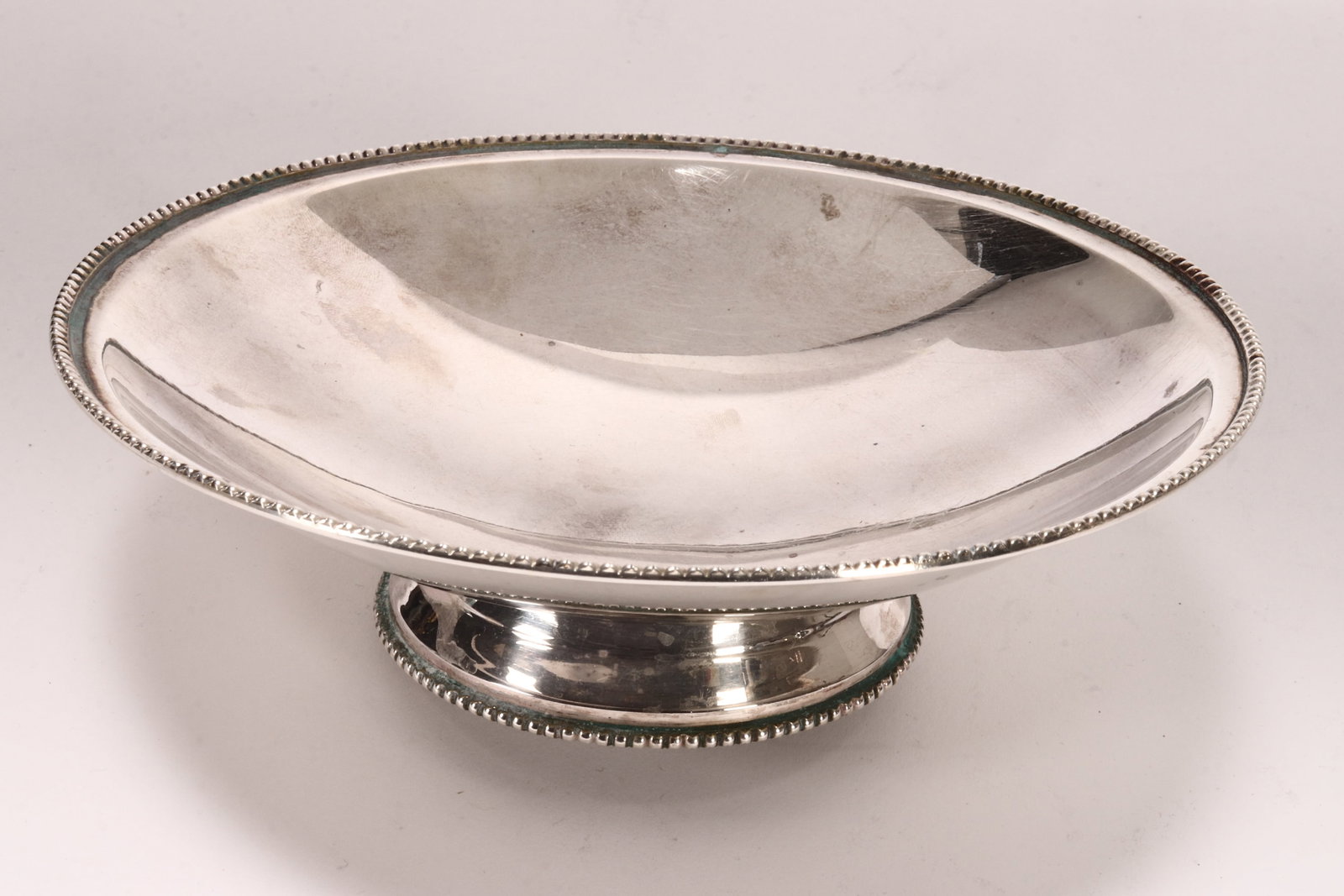 George VI Sterling Silver Footed Bowl,: hallmarked Sheffield, 1946, J.D&S (James Dixon & Sons Ltd), with a plain shallow bowl, accented with beaded border, raised on a circular foot, total weight 233g, height 4.5cm and diameter 16cm