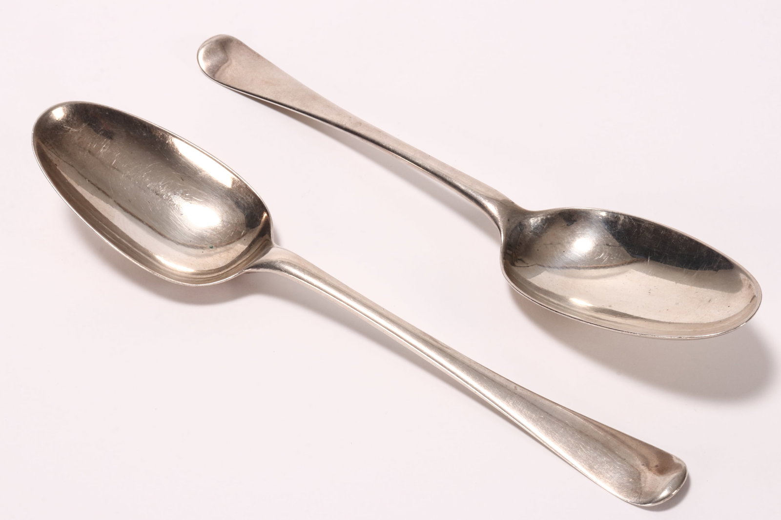 Pair of George I Sterling Silver Table Spoons,: hallmarked London, 1722, I.W (John Wilkes), in Hanoverian pattern, with oval shaped bowls, total weight 108g, length 20cm (2) Purchased: David Morris, United Kingdom, 1983.