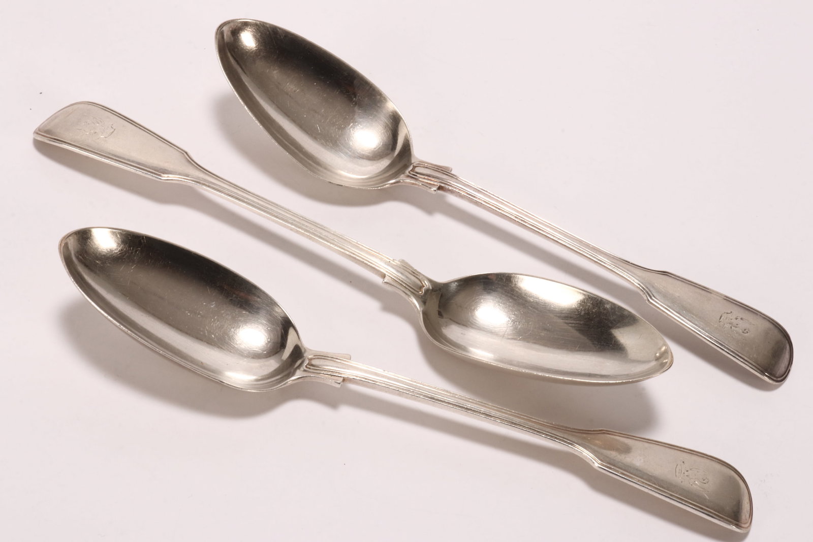 Set of Three Victorian Sterling Silver Spoons,: hallmarked London, 1867, GA (Chawner & Co.-George William Adams), in fiddle and thread pattern, decorated with monogram of a winged mythical creature holding a crown to terminal, total weight 260g, le