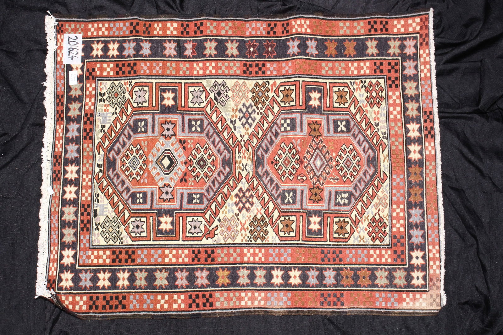 Persian Afshar Rug,: or rectangular form, set with two elephant foot medallions, surrounded by star and geometric motifs, in tones of red, green, blue and white, 104cm x 82cm