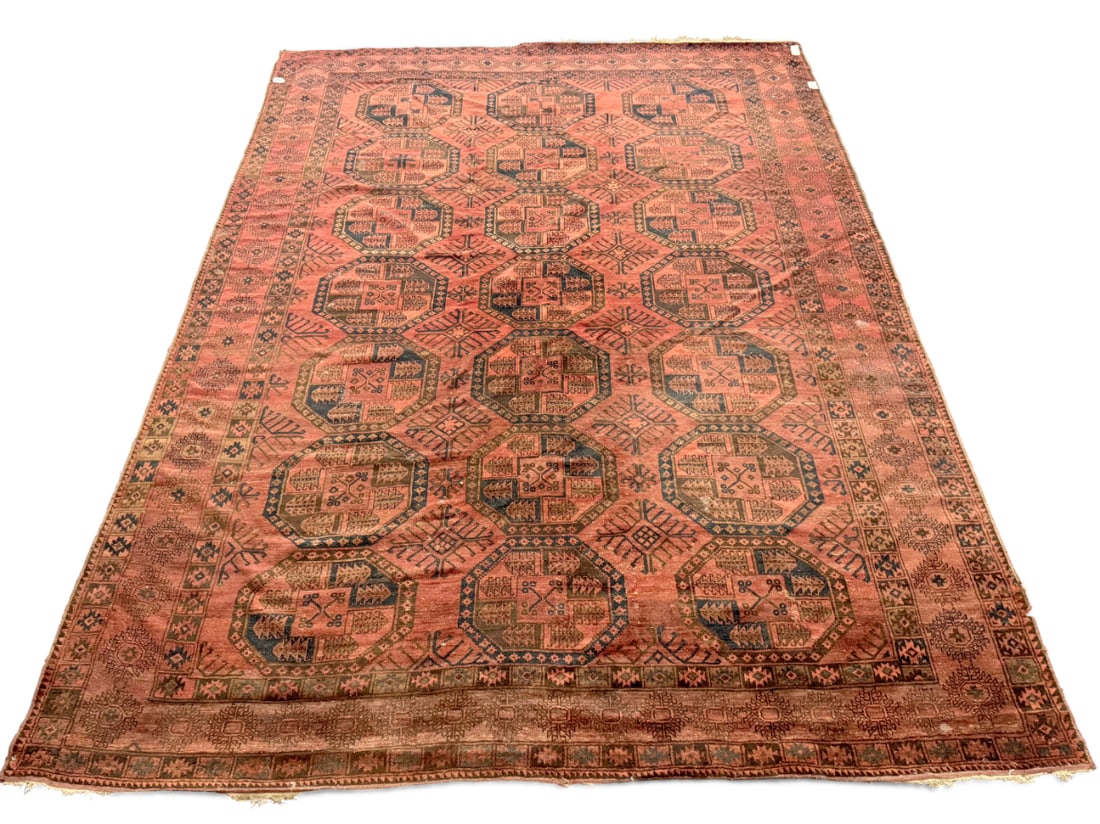 Large Afghan Turkmen Rug,: of rectangular form, the central panel set with multiple large elephant foot medallions, accented with stylised foliage, surrounded by multiple geometric borders, in rich tones of red, blue, orange an
