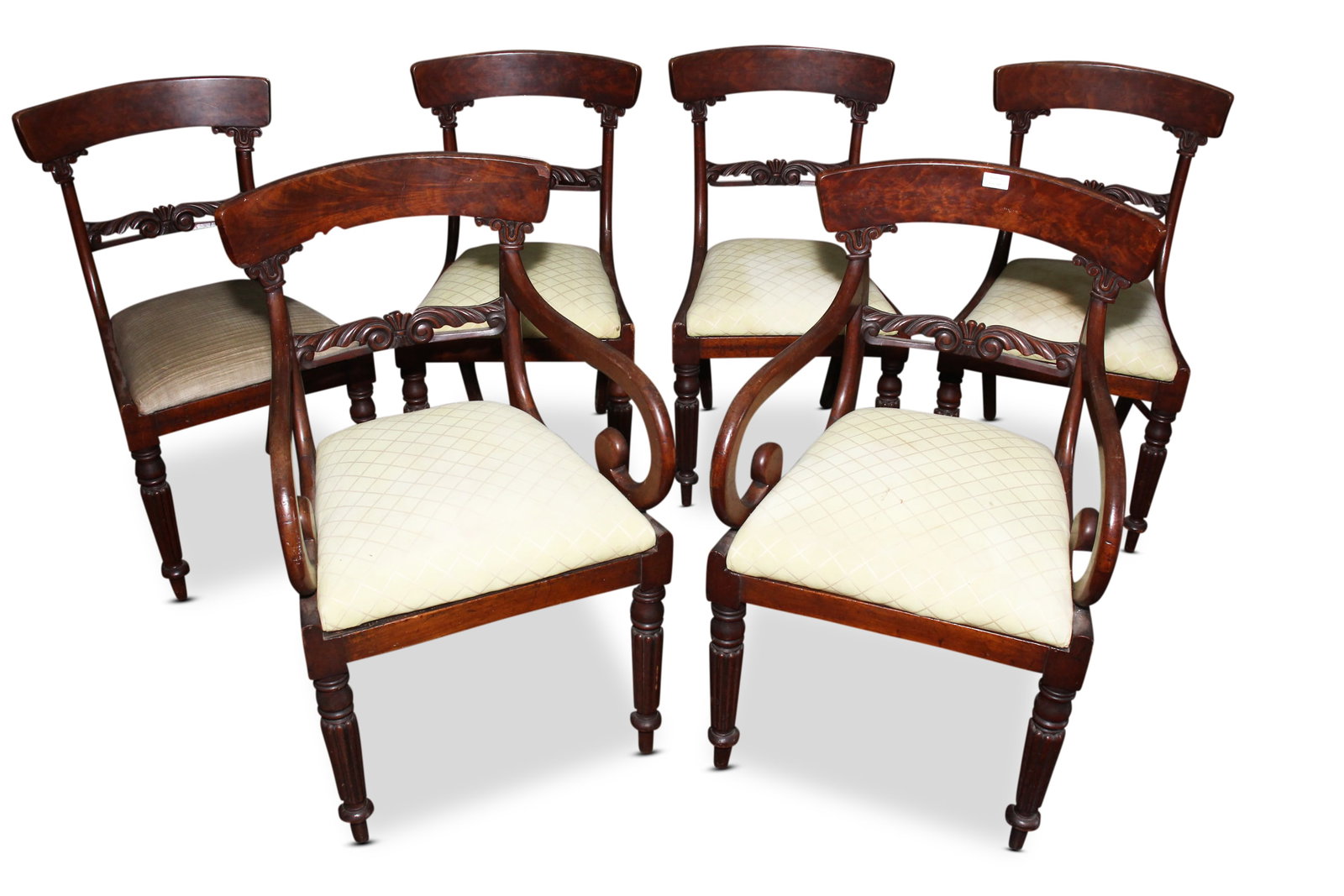 Set of Six William IV Dinning Chairs,: including two carvers, with curved crest rails, above a carved acanthus splat, flanked by scrolled arms, above an upholstered drop in seat, on four tapered reeded legs (6)