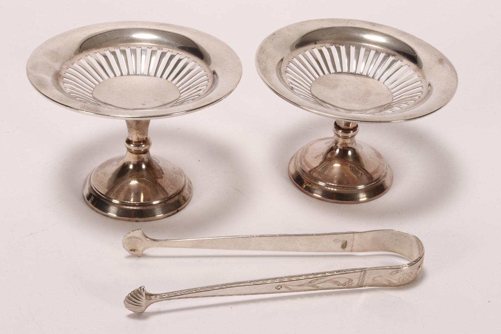 Pair of George V Sterling Silver Comports,: hallmarked Chester, 1911, S.B & S Ltd (S Blanckensee & Son Ltd), of shallow pierced form, above a knopped stem, the whole raised on a stepped circular base, together with a pair of sterling silver sug