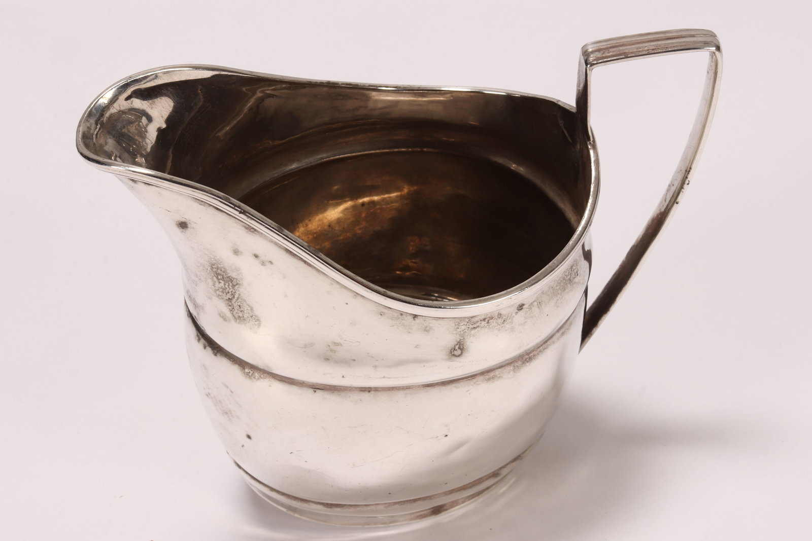 Georgian Sterling Silver Creamer,: marks rubbed, the plain elliptical form, with angled handle, total weight 81g, height 9.5cm