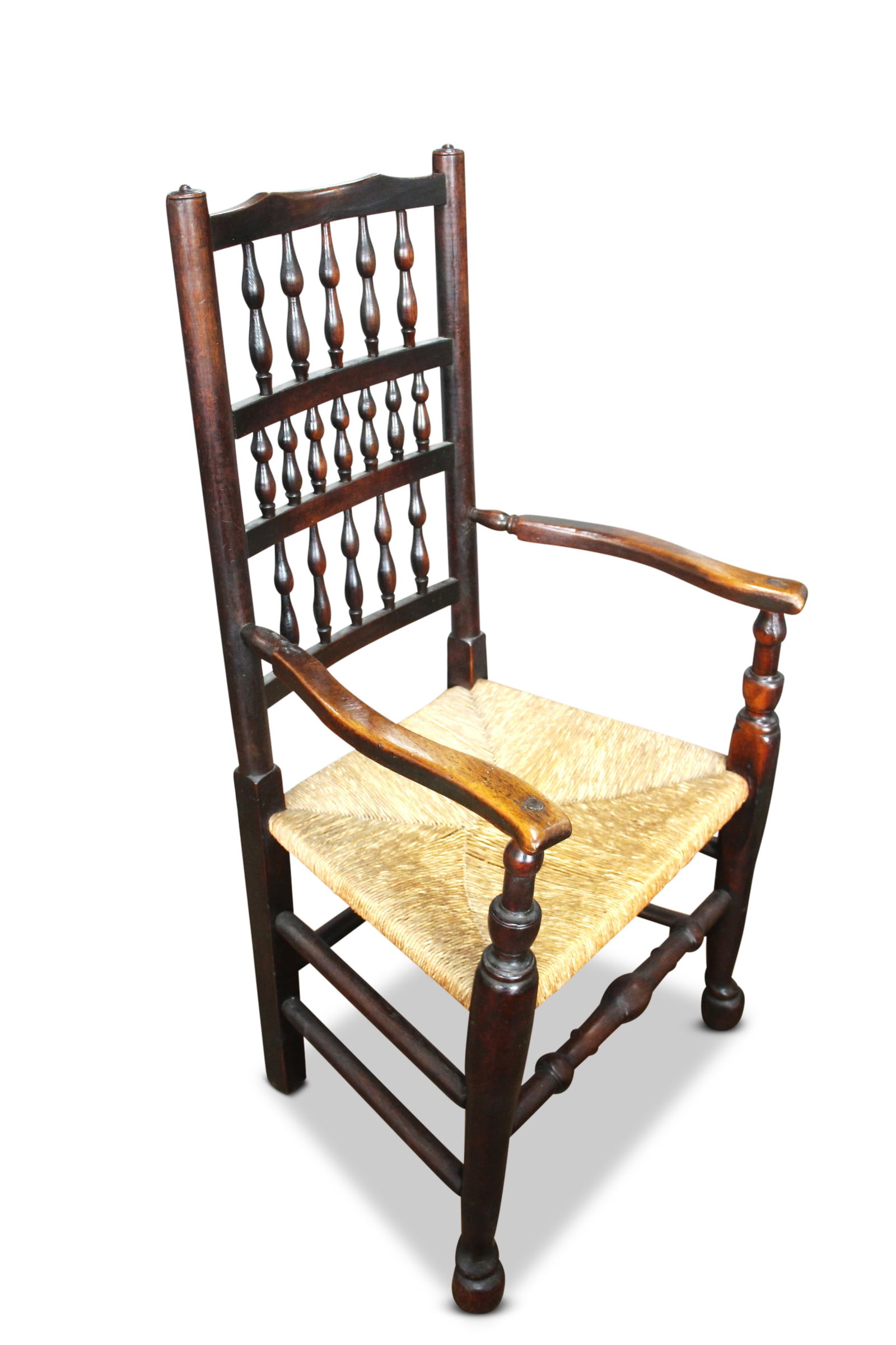 Georgian Lancashire Spindle Back Carver,: with rush seat, on turned supports, united by stretchers, height 112cm x width 61cm x depth 45cn