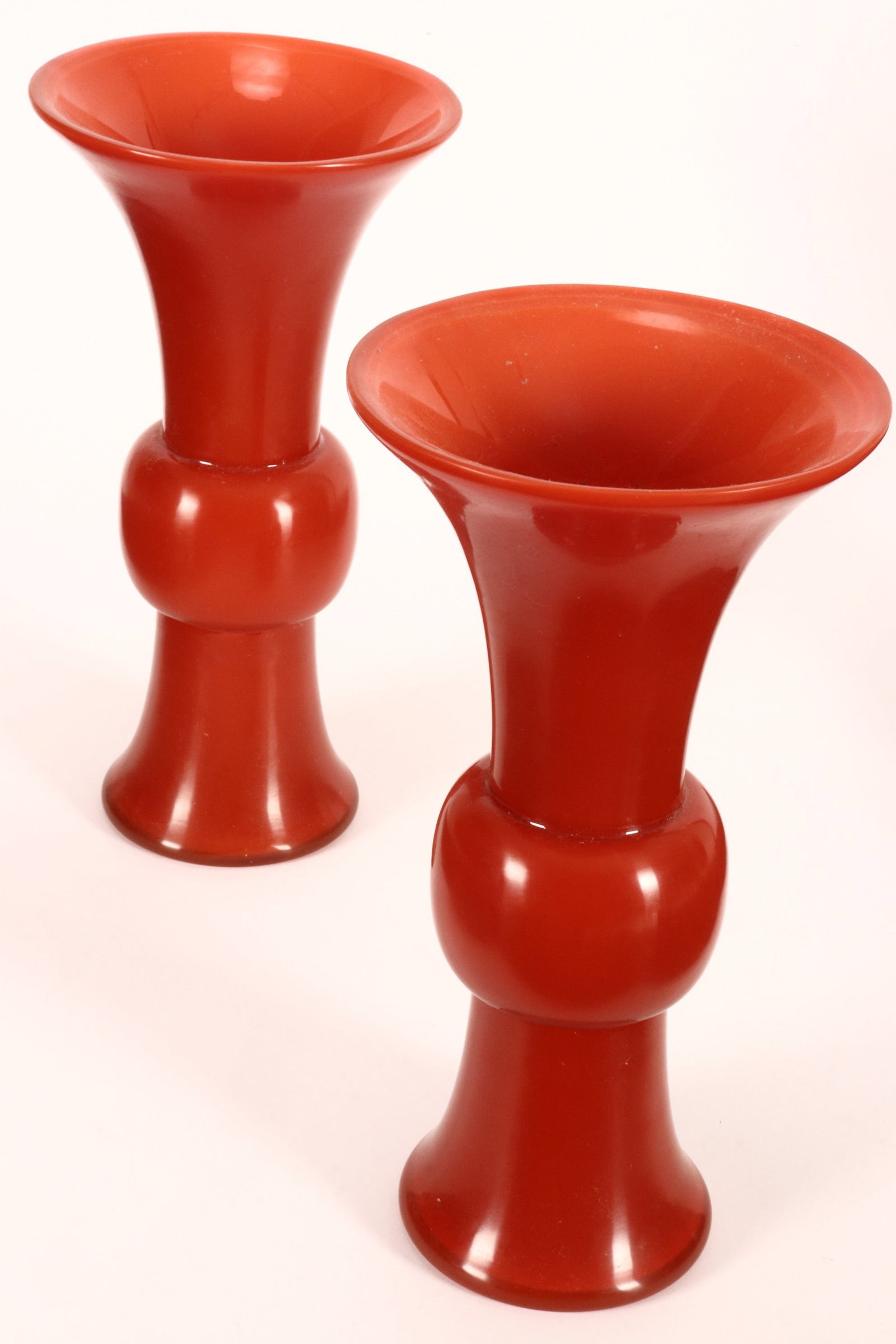 Pair of Chinese Peking Glass Gu Vases,: of handsome proportions in deep orange/red glass, with tapering lip above a knop body and spreading foot, height 34.5cm (2)