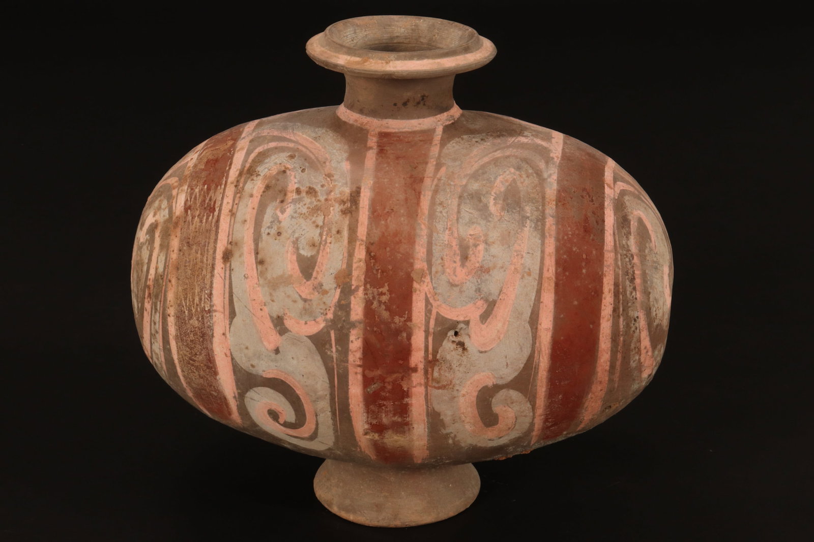 Chinese Han Dynasty (206 BCE-220CE) Cocoon Jar,: with spreading lip, above a baluster body on spreading foot, decorated with stylised line and scroll work, in tones of pink, blue and iron red, possible repainting, 15cm x 28cm