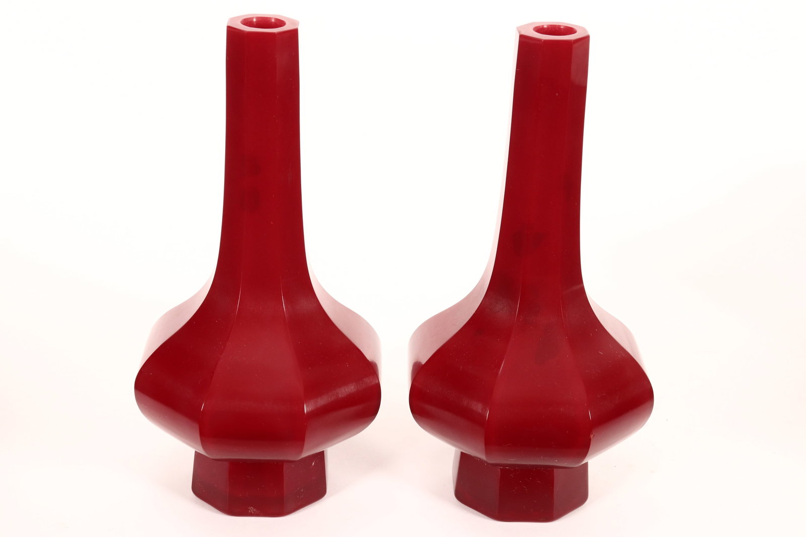 Pair of Chinese Peking Glass Vases,: of facetted baluster form, in a deep red glaze, raised on spreading facetted foot, height 20cm