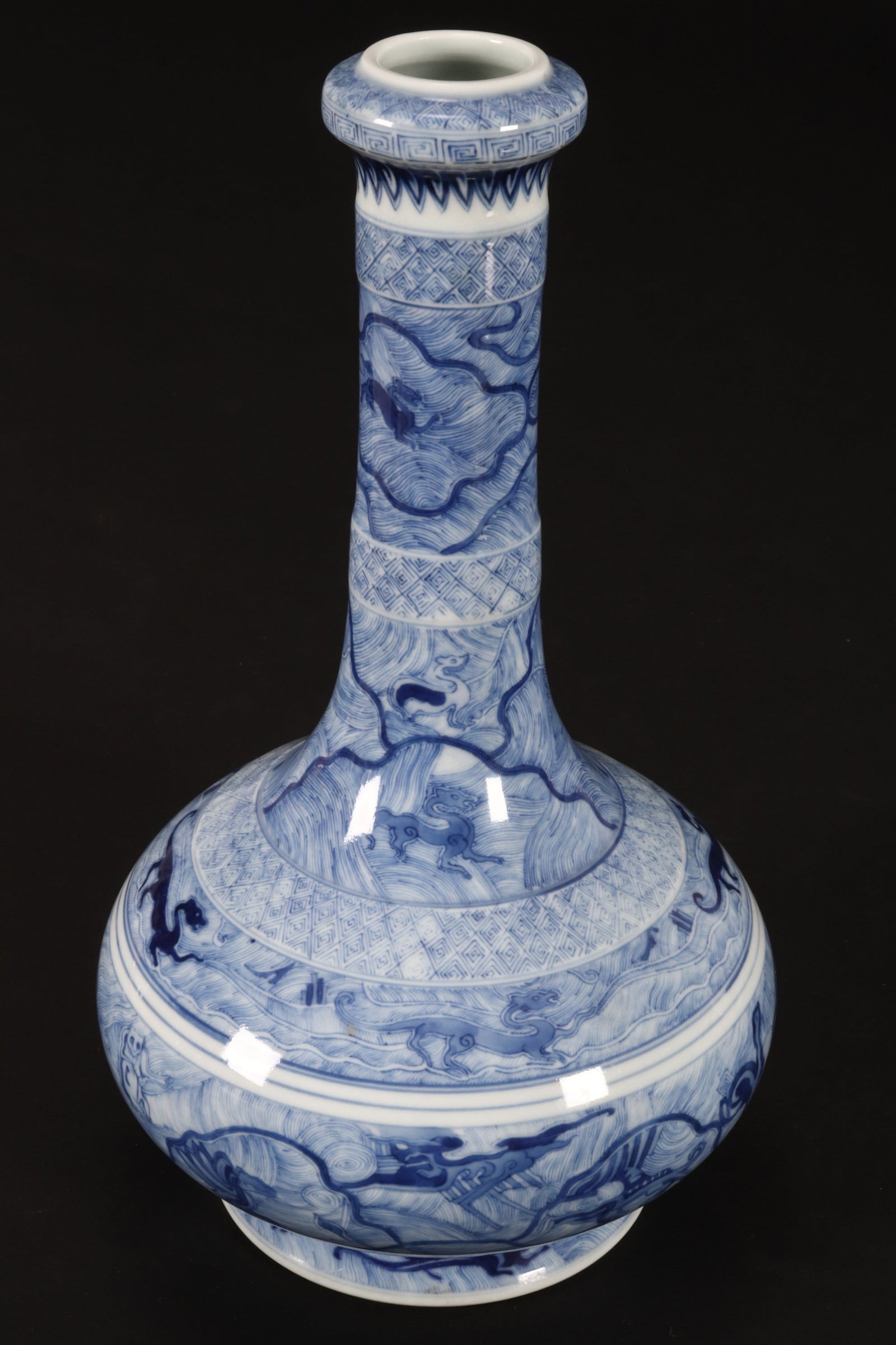 Chinese Blue and White Porcelain Vase,: of garlic head form, decorated with key-fret and palmette borders to the rim, neck and body, decorated with scenes of Archaic style mythical creatures amongst turbulent waves, flanked by concentric di