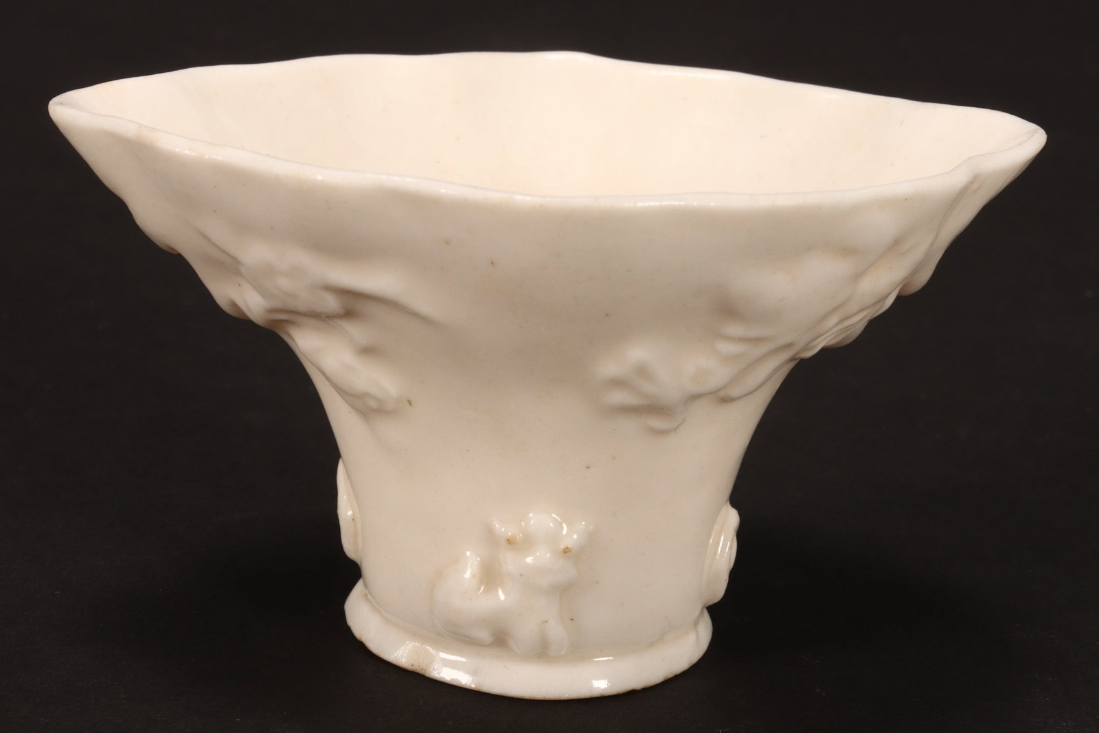 Chinese Qing Dynasty Dehua Libation Cup,: of typical form, decorated with dragons, kylins and birds, in a white glaze, 9cm x 5cm