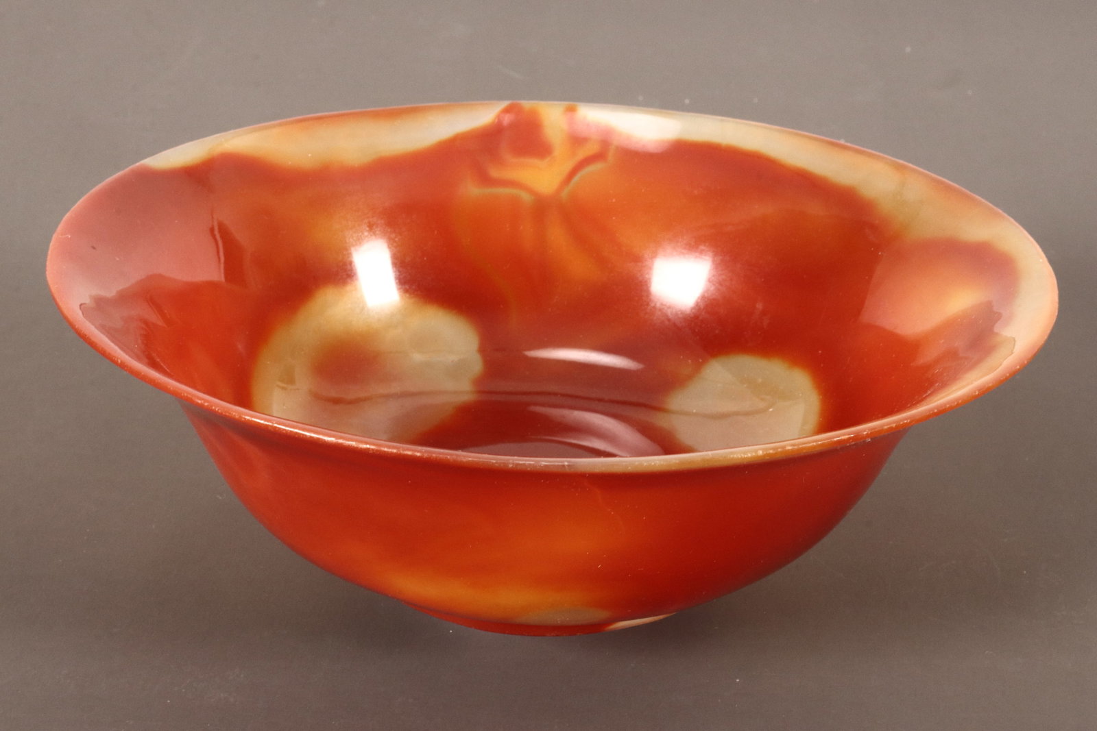 Chinese Carved Agate Bowl,: of conventional form, with everted rim,the whole in tones of orange and semi-opaque yellow, mark to base, height 6.5cm, diameter 19cm