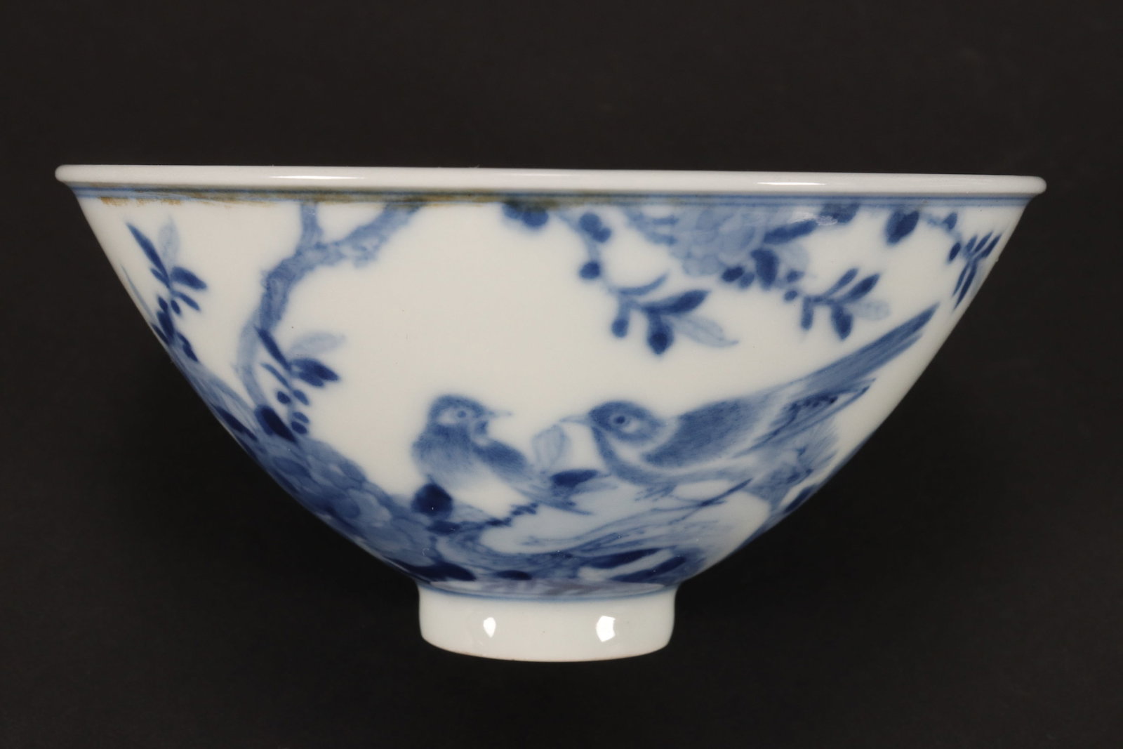 Chinese Blue and White Porcelain Tea Bowl,: of conical form, the interior decorated with foliate spray, the exterior with two birds on a blossoming branch, blue seal mark to base, height 4.5cm and diameter 9.5cm