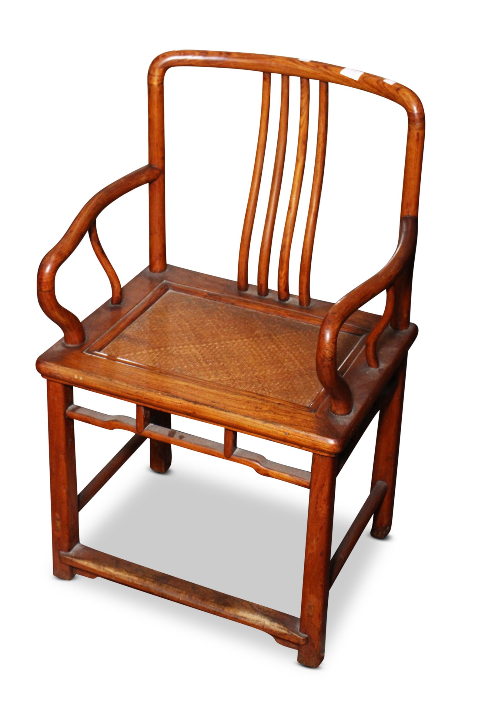 Chinese Carved Wooden Arm Chair,: with a slightly curved crest rail, above spindle splats, flanked by shaped arms, above a rectangular caned seat, on four tapered facetted legs, united by stretchers