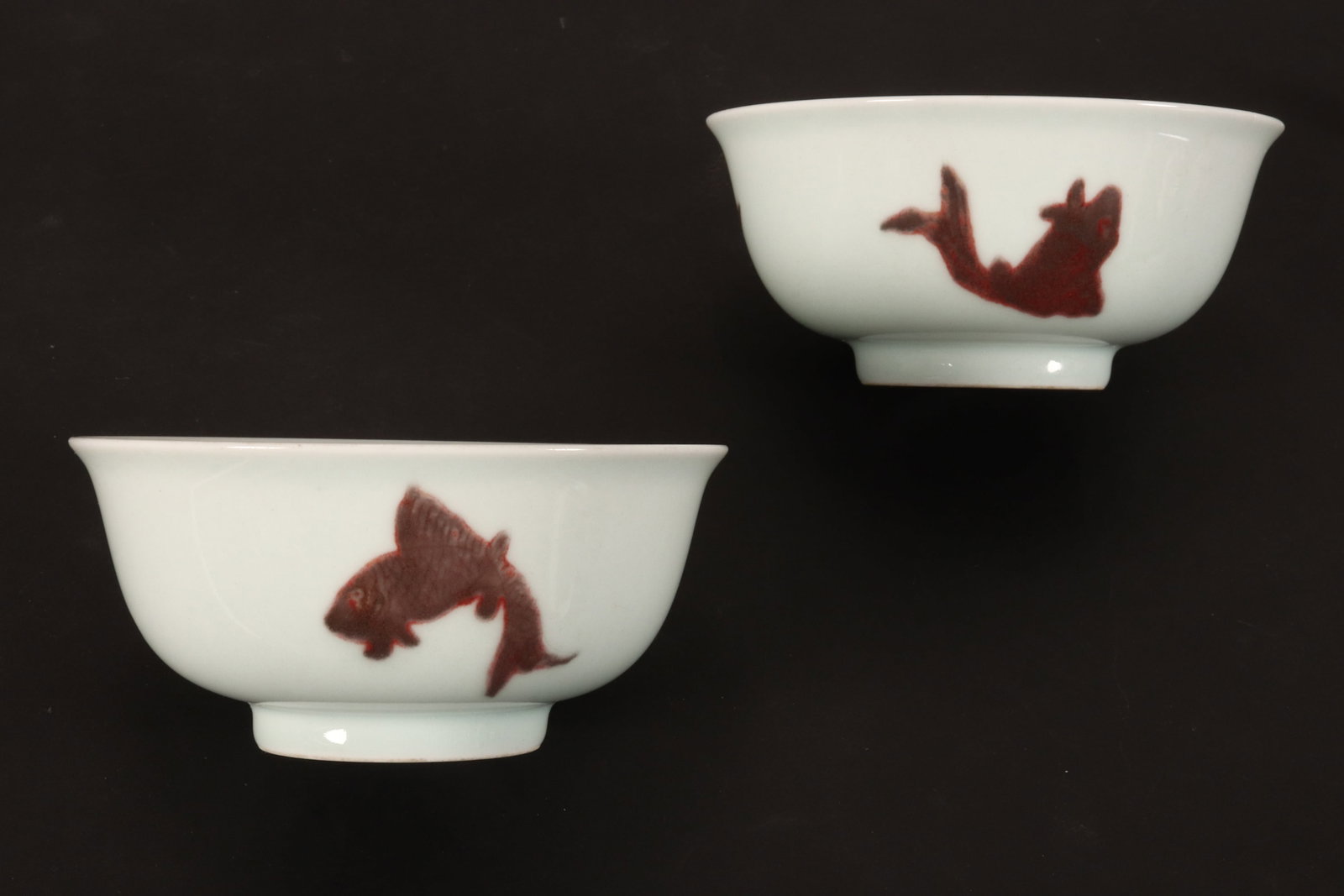 Pair of Chinese Porcelain Bowls,: of conventional form with a slightly flared rim, decorated with three fish motifs to exterior, in tones of iron red, grey and yellow on a white ground, raised on a circular foot, six character mark wi