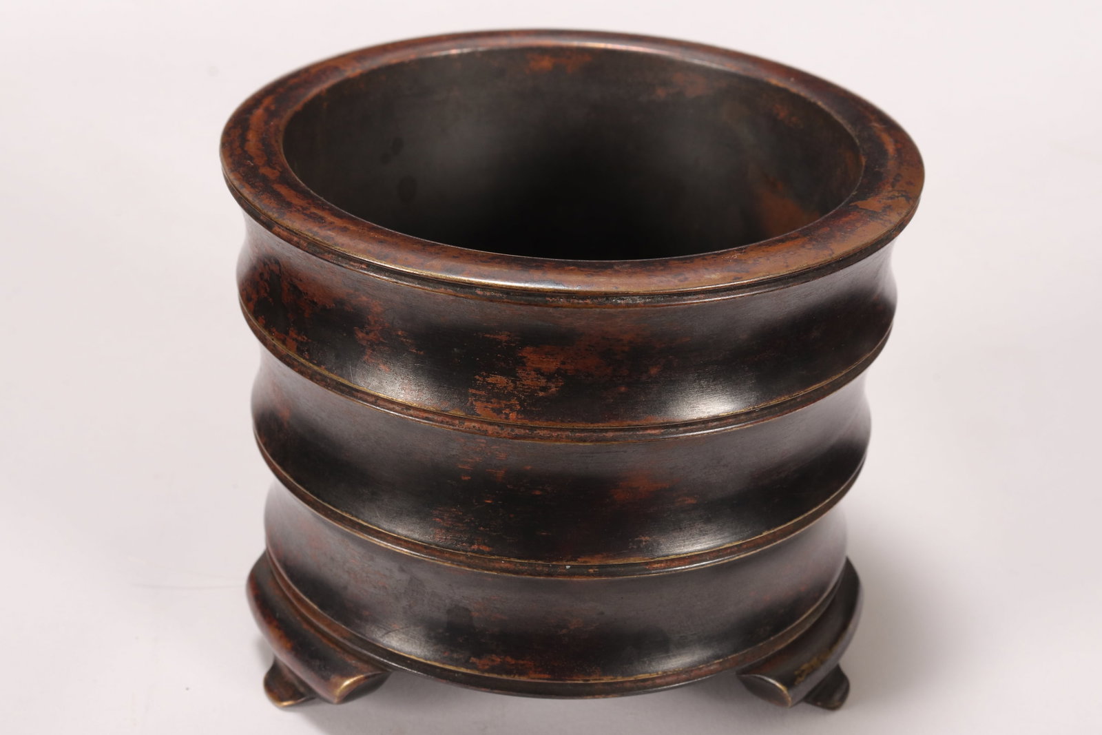 Chinese Bronze Censer,: of banded cylindrical form, raised on three ruyi form feet, seal mark to base, height 6.5cm and diameter 8cm