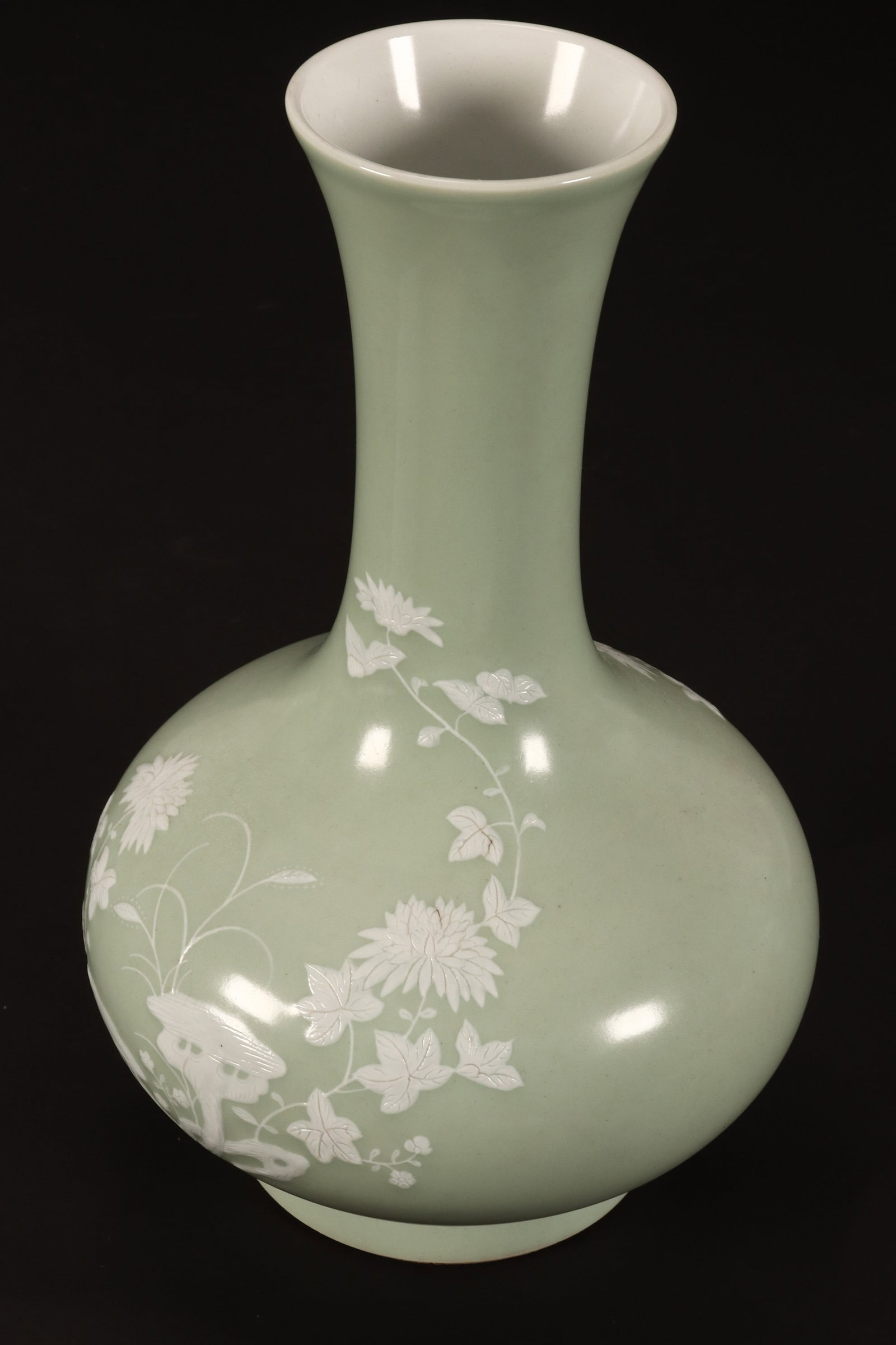 Chinese Porcelain Pate-sur-Pate Vase,: of baluster form, decorated with a scene of flowers, foliage and butterfly in relief, in white tones on a pale green ground, raised on a circular foot, six character mark to base, height 34.5cm