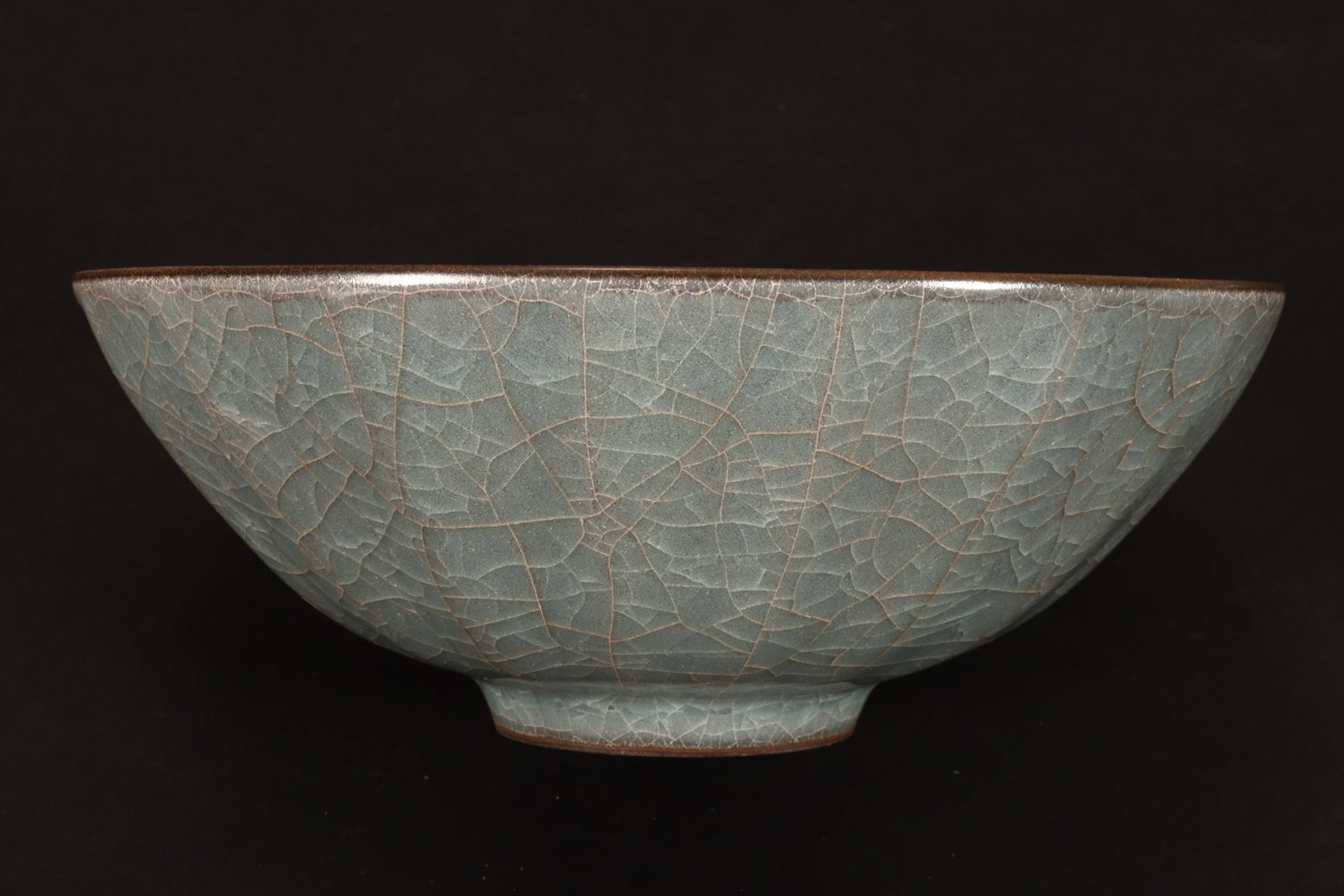 Chinese Crackle Glaze Bowl,: of facetted circular form, decorated with a pale blue and brown crackle glaze, standing on a raised circular foot, diameter 16.5cm