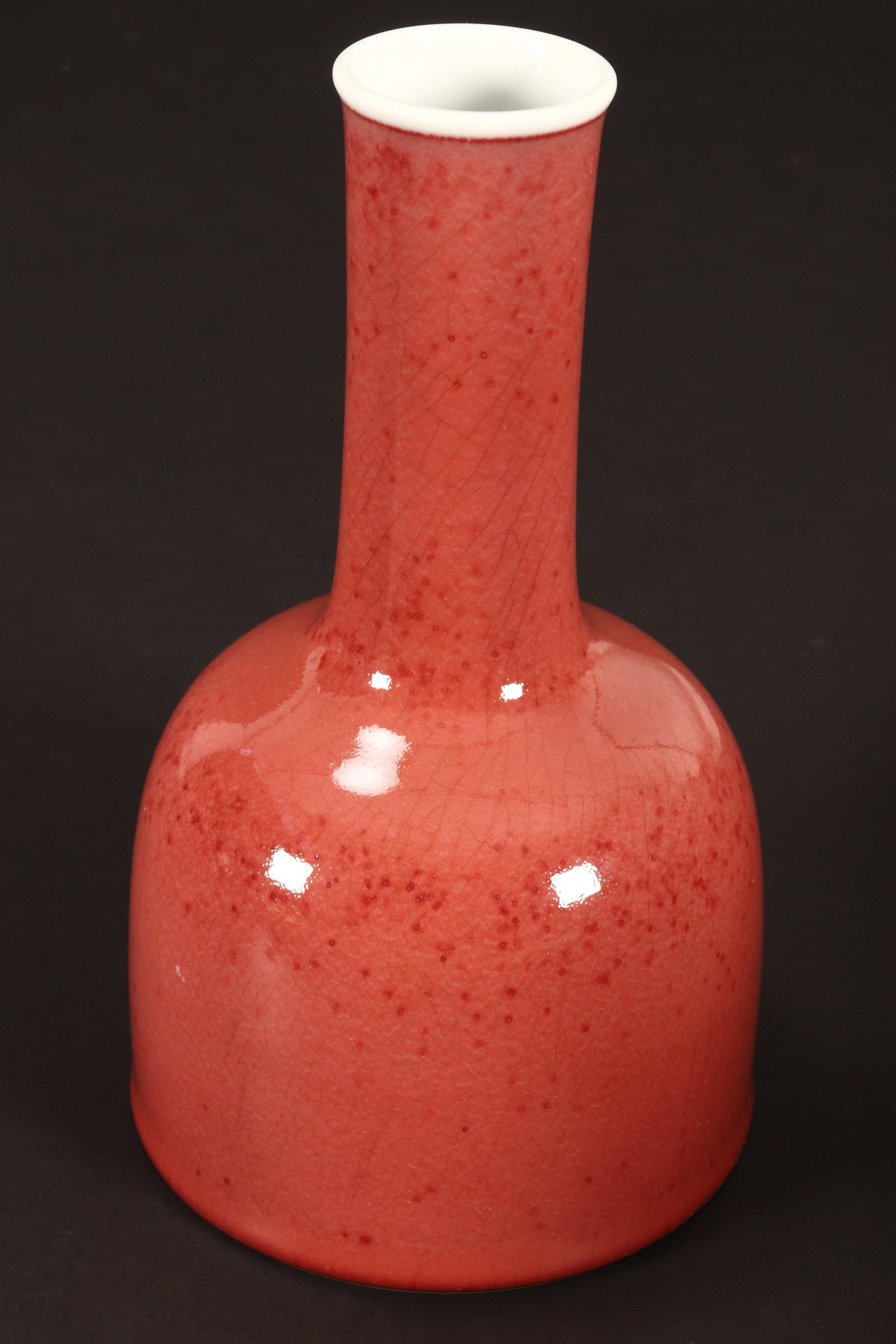 Chinese Peach Blossom Glaze Vase,: of mallet form, decorated with a mottled and crackled pale red glaze with white interior, six character mark to base, height 19.5cm