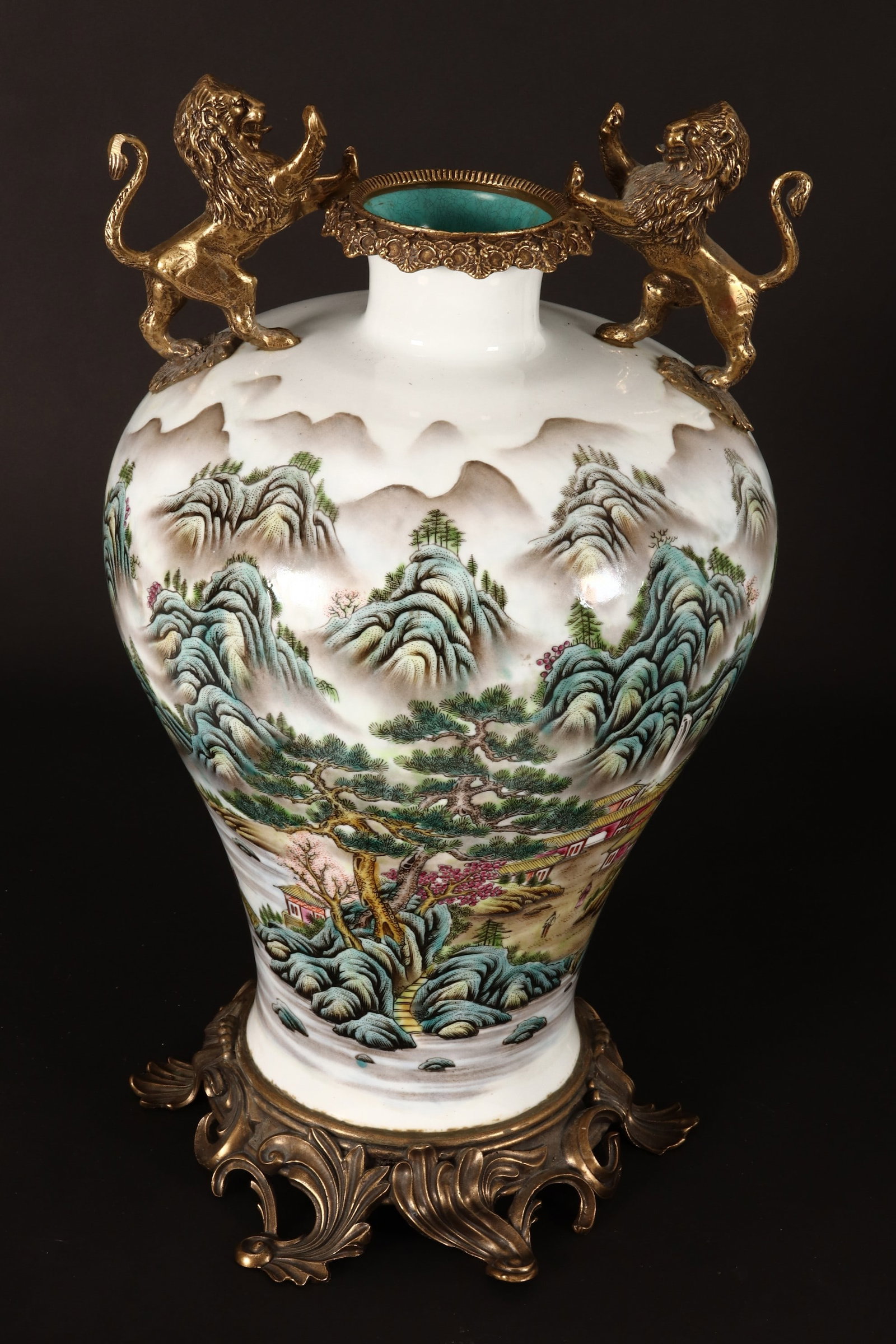Chinese Famille Rose and Gilt Brass Mounted Porcelain Vase,: the vase of meiping form, decorated continuously with mountainous landscape scene with river and village below, blue seal mark to base, set between a a gilt brass rim flanked by twin lion handles, rai