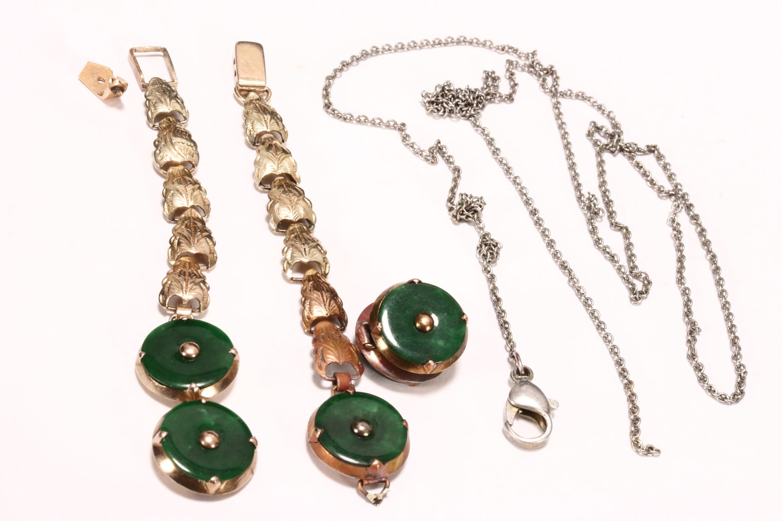 Chinese 14ct Gold and Jade Bracelet,: stamped 14K to clasp, the foliated form chain set with five jade medallions, in mottled green tones, a/f (multiple breaks), together with a white metal chain