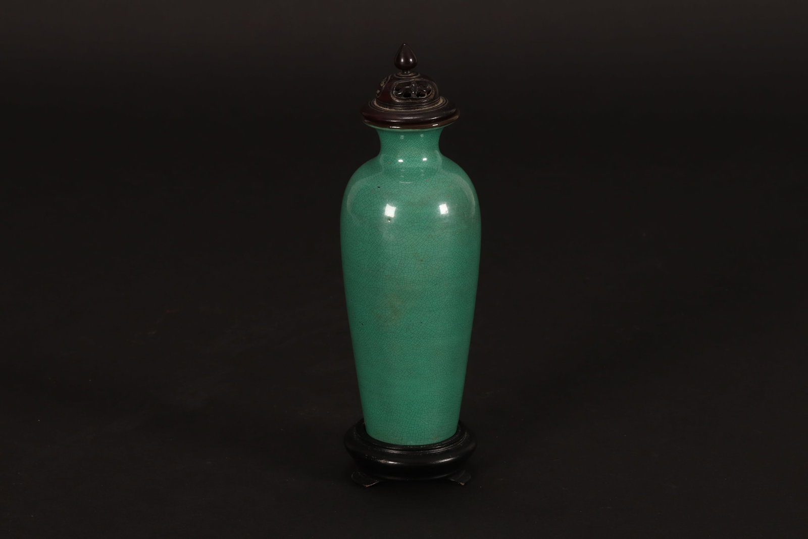 Chinese Green Crackle Glaze Vase, Cover and Stand,: of slight tapering elongated cylindrical form, with short neck and everted rim, with pierced wooden cover, and circular wooden stand, height 15cm and 20cm (including cover and stand)
