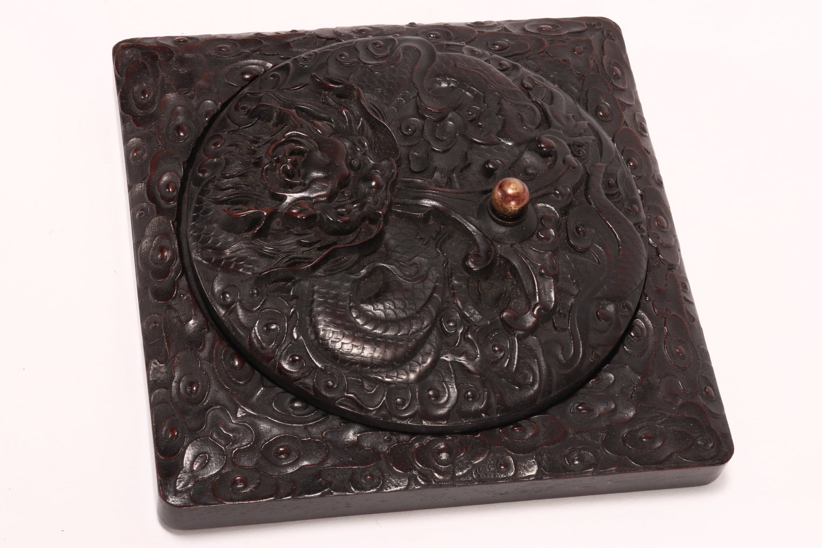 Chinese Late Qing Dynasty Wooden Ink Stone Box,: of square form, with circular well and cover, nicely carved with dragon amongst stylised clouds, with simulated flaming pearl handle, 5cm x 16cm x 16cm