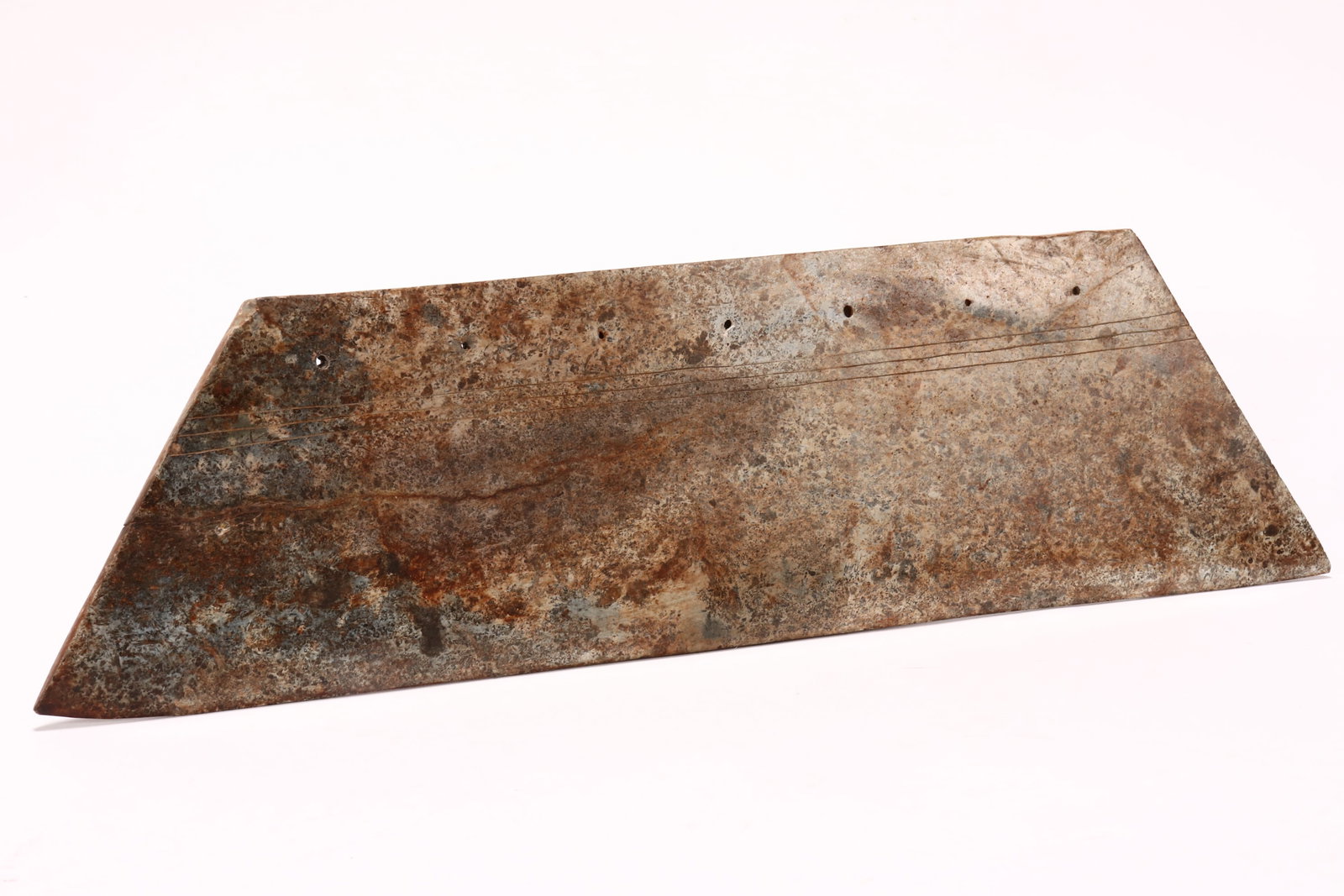 Large Chinese Carved Stone Adze Head,: of trapezoid form, set with pierced holes to top, above incised decoration, in tones of brown, white, green and black, a/f (chip to corner), 44cm x 11cm