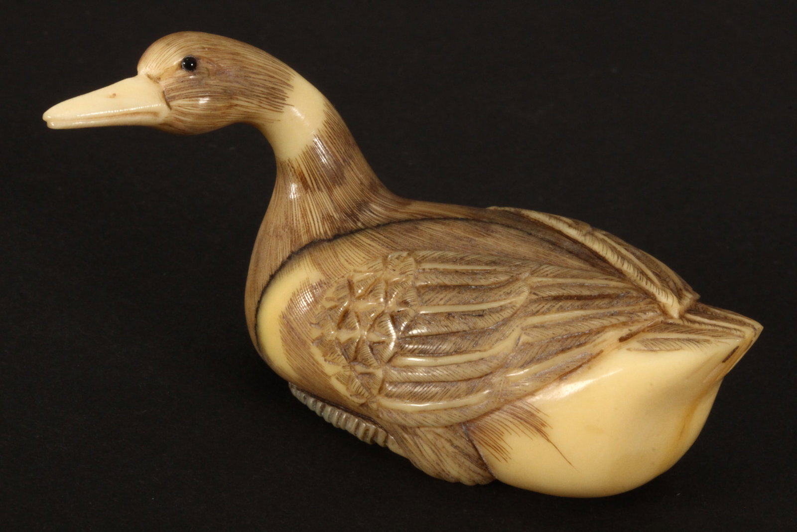 Japanese Netsuke,: carved in the form of a duck with head slightly turned, incised signature to base, a/f, length 5.5cm. Please note this item can only be shipped WITHIN Australia.